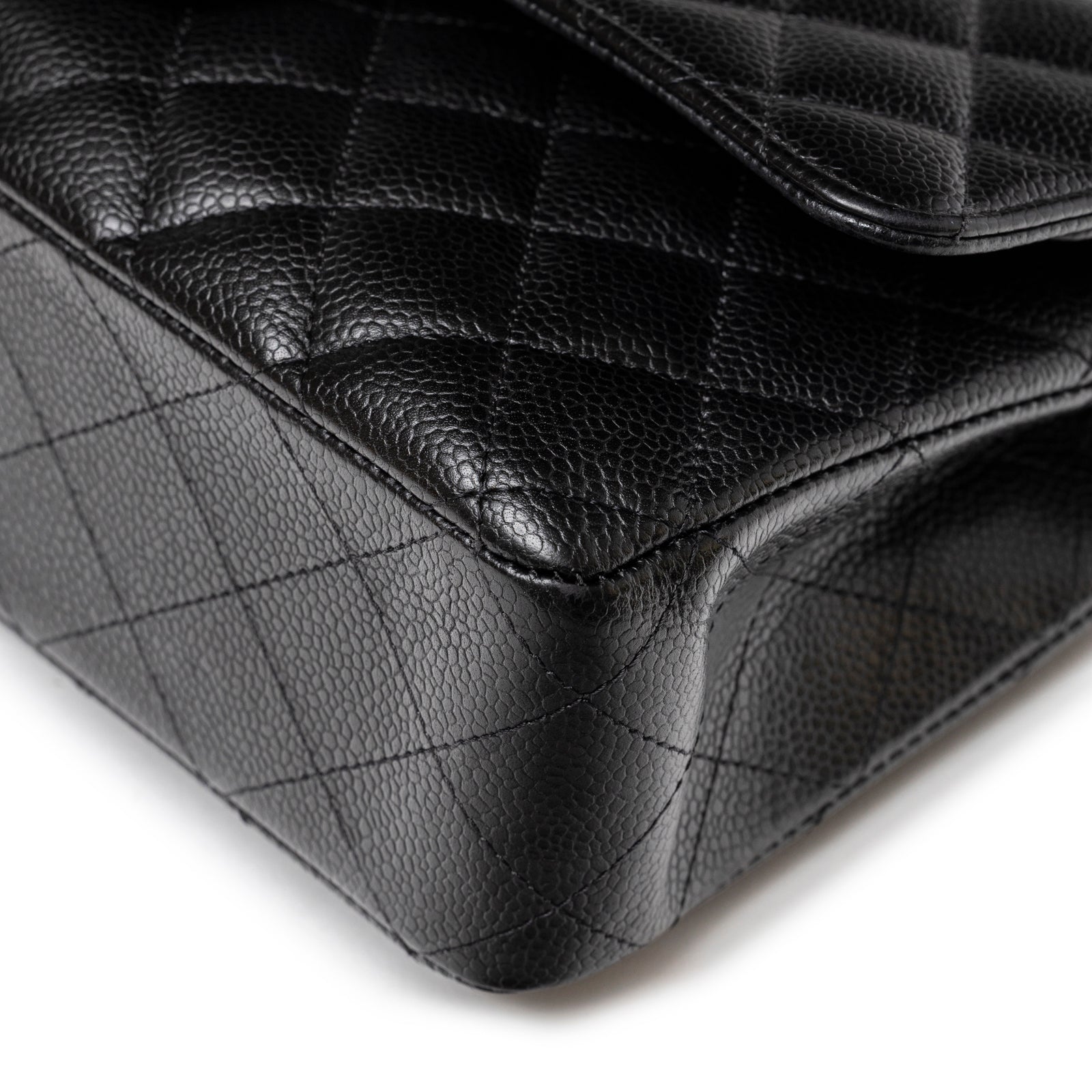 Close-up of corner stitching and textured leather on Chanel Medium Classic Flap Bag Black Caviar Palladium Hardware