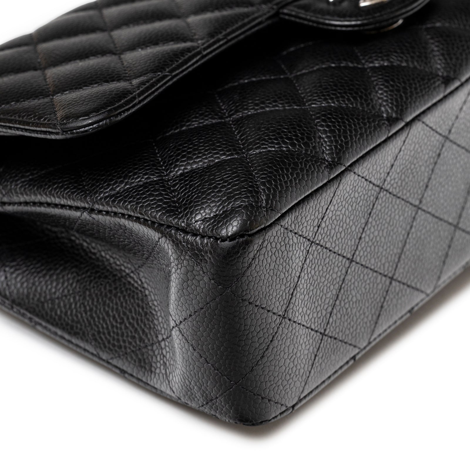 Close-up angled view of corner showing textured leather and quilted pattern on Chanel Medium Classic Flap Bag Black Caviar Palladium Hardware