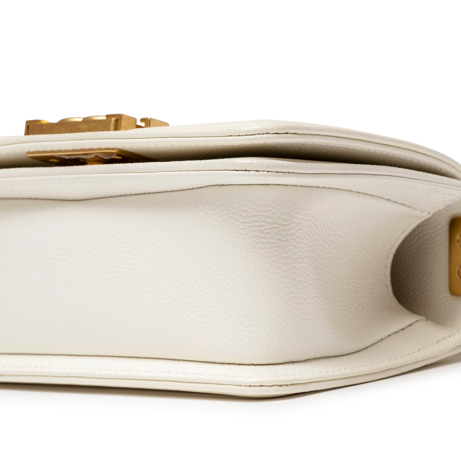Close-up of bottom side showing white caviar leather texture and gold hardware on Chanel Mini Boy Bag White Caviar Gold Hardware