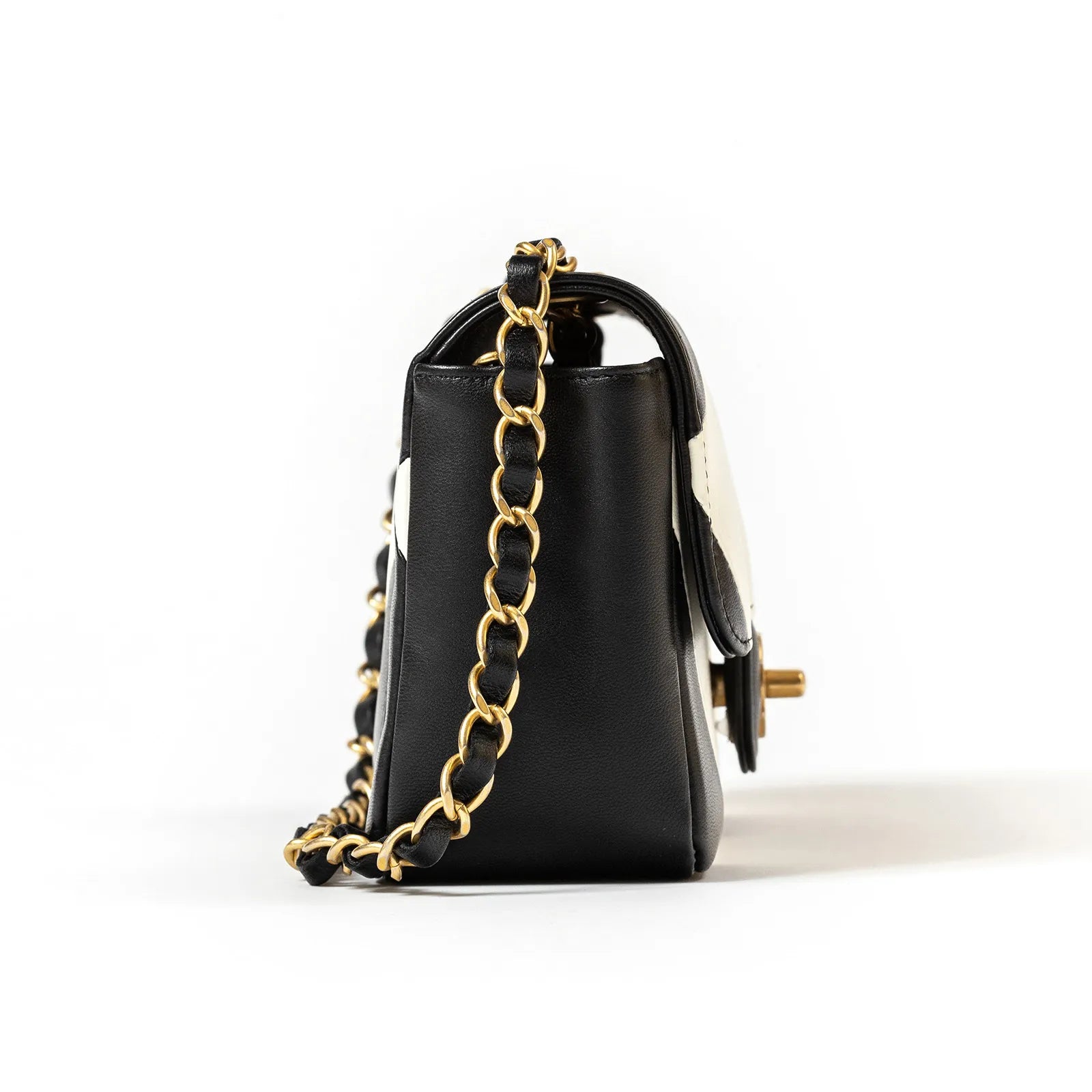 Side view of Chanel Geometric Patchwork Mini Flapbag Gold Hardware showing black leather and gold chain strap details