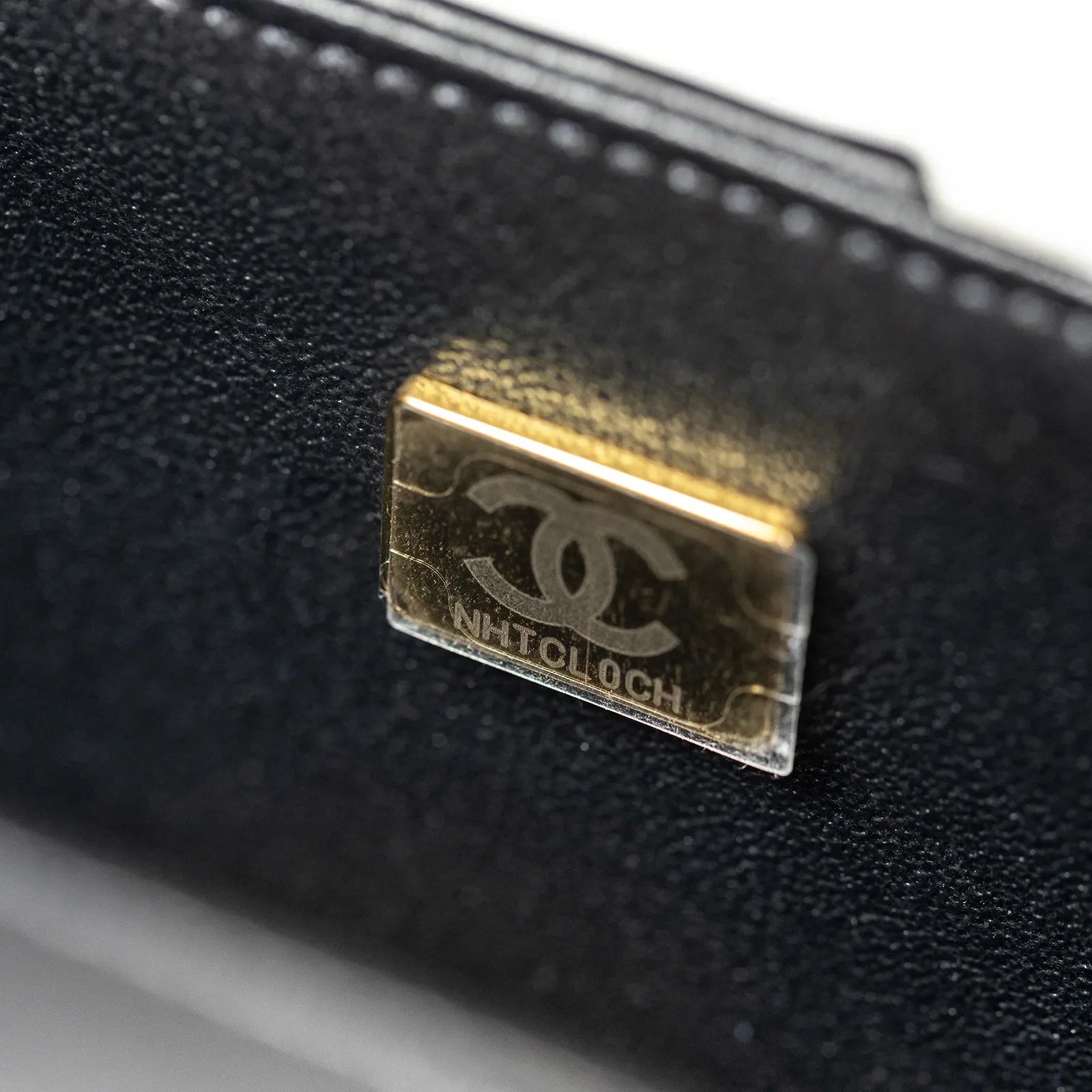 Close-up of gold hardware logo plate inside Chanel Geometric Patchwork Mini Flapbag Gold Hardware showing fine detail
