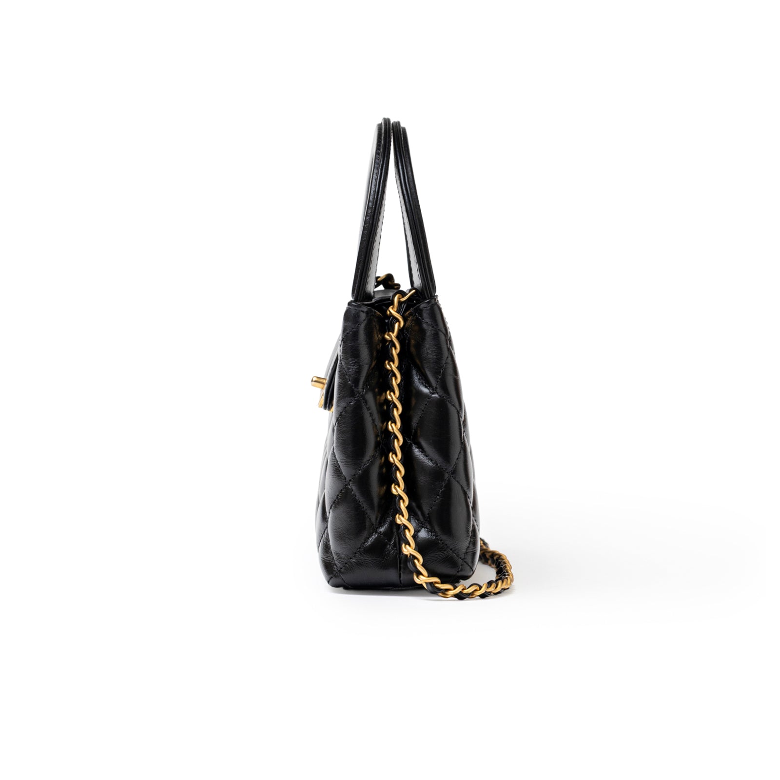 Side view of Chanel Mini Kelly Shopper Black Shiny Aged Calfskin Brushed Gold Hardware showing chain strap and quilting details