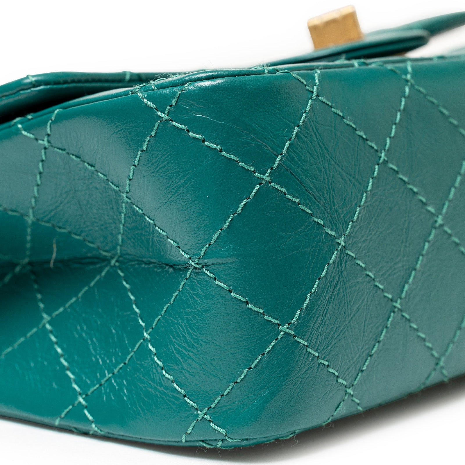 Close-up of the green calf leather corner with diamond stitching on the Chanel Mini Reissue 2.55 Flap Bag Green Calf Brushed Gold Hardware