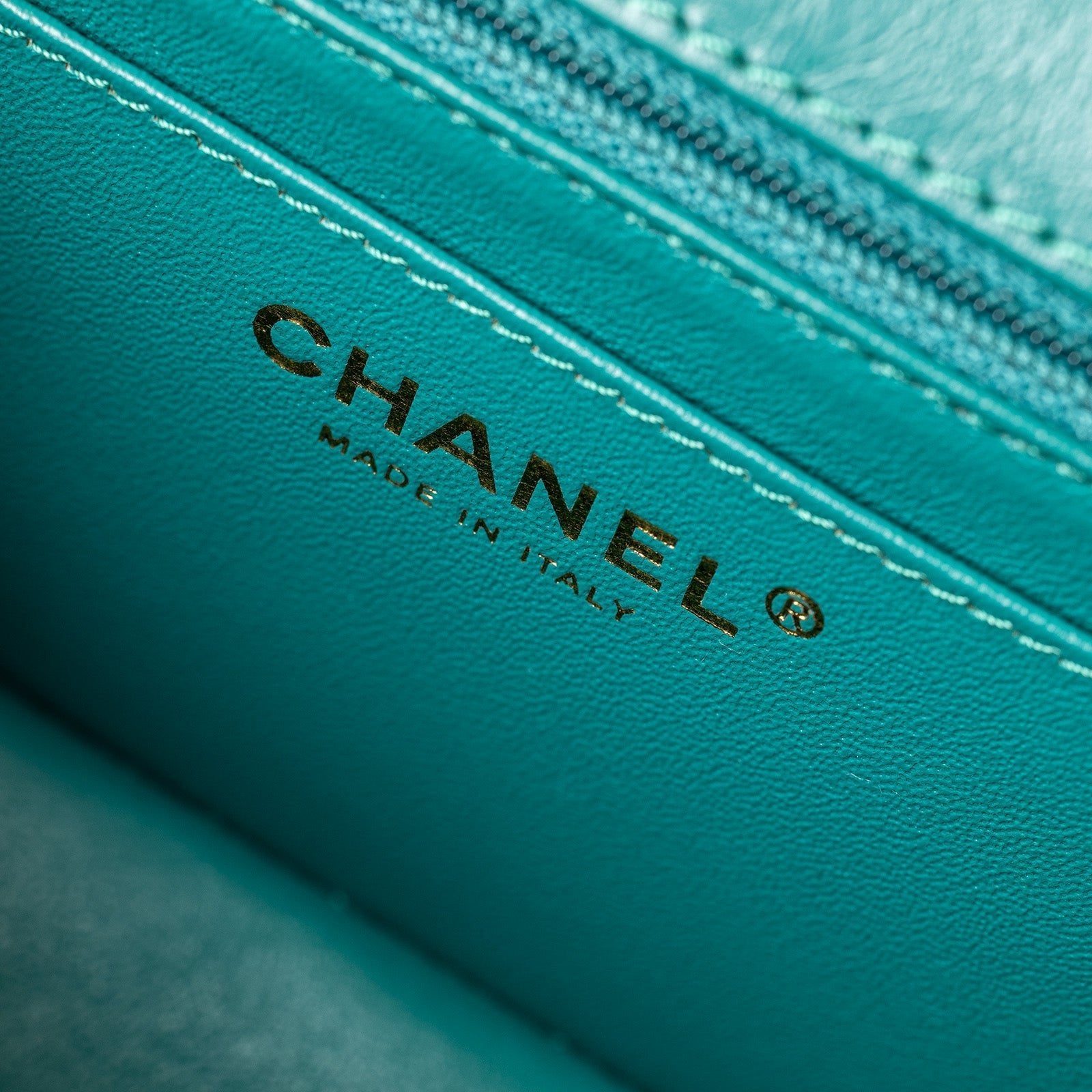 Close-up of interior logo and stitching detail inside Chanel Mini Reissue 2.55 Flap Bag Green Calf Brushed Gold Hardware