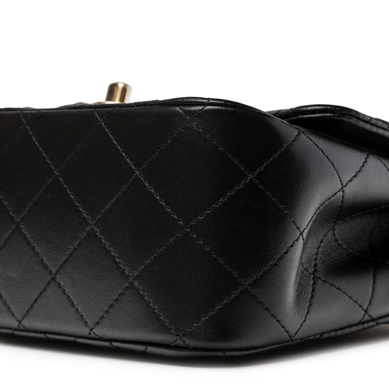 Close-up bottom view of Chanel Mini Square Classic Flap bag Black Lambskin Light Gold Hardware showing smooth quilted leather texture