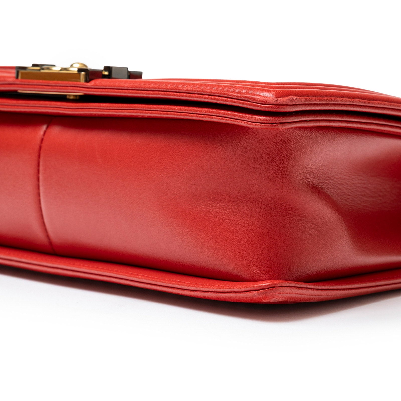 Close-up bottom view of Chanel Mini Square Classic Flap bag Red Lambskin Gold Hardware showing smooth leather texture and stitching details