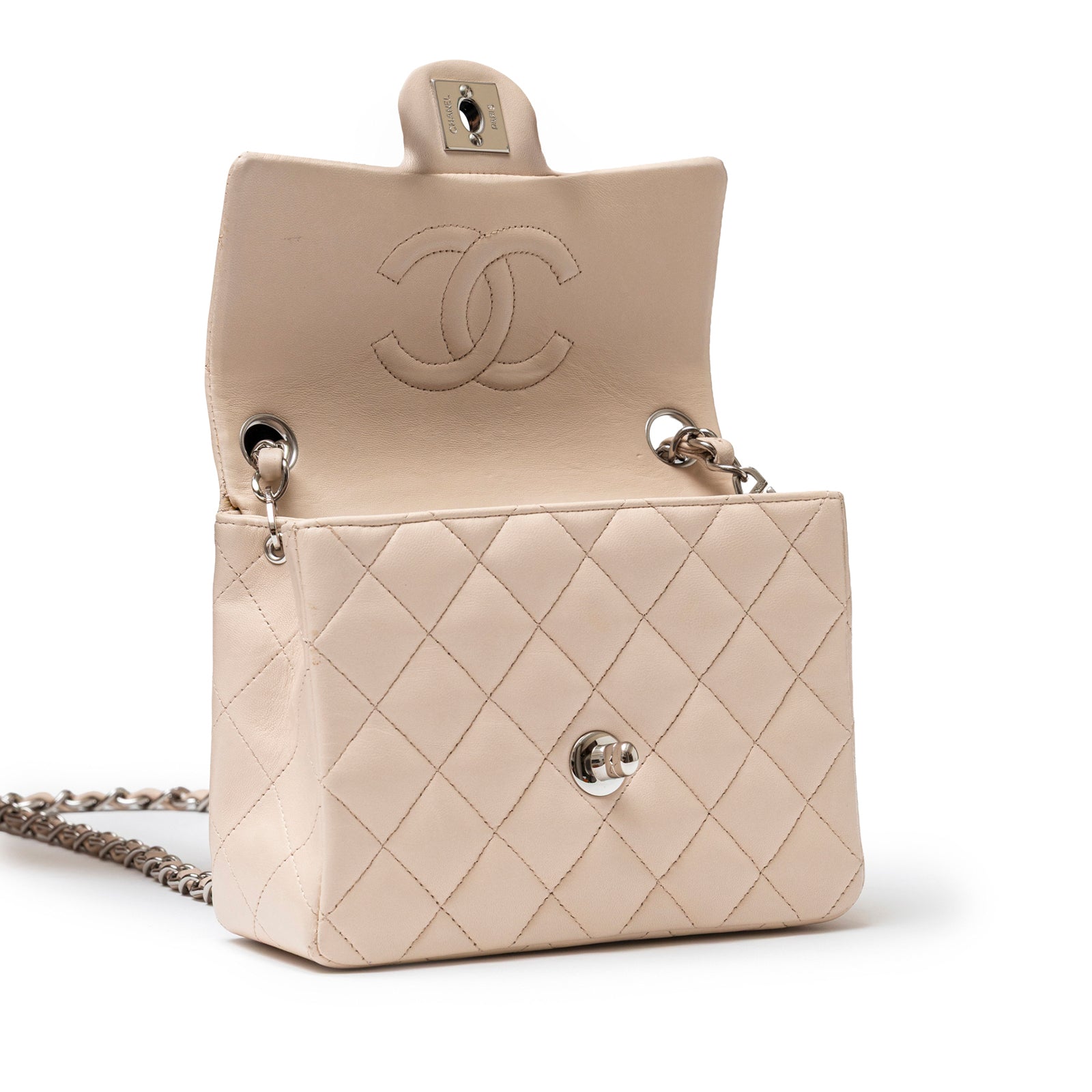 Open angled shot of Chanel Mini Square Single Flap Lambskin Beige Silver Hardware showing quilted exterior and interior logo embossing