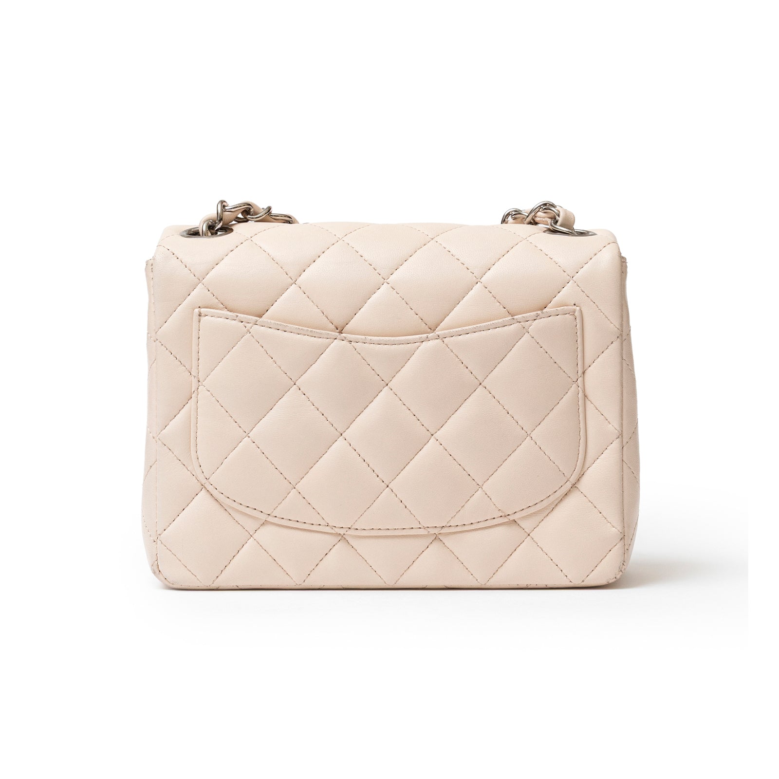 Rear view of Chanel Mini Square Single Flap Lambskin Beige Silver Hardware showing quilted pattern and outer pocket.