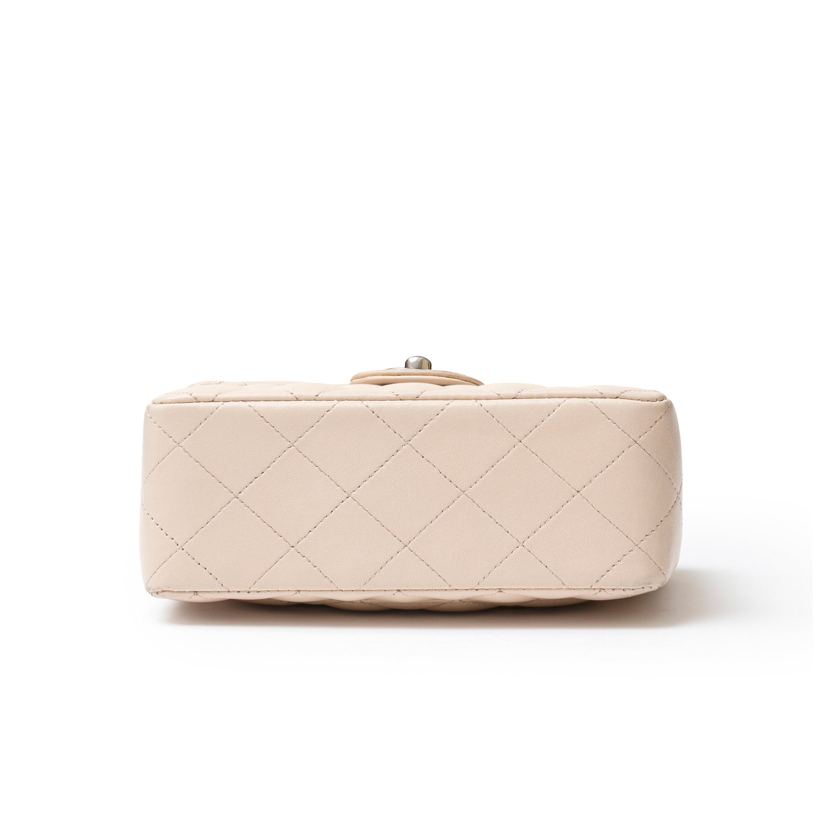 Bottom view of Chanel Mini Square Single Flap Lambskin Beige Silver Hardware showing quilted leather base