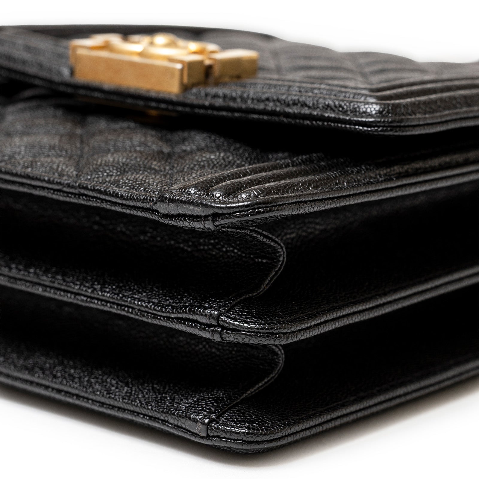 Close-up of side detail on Chanel North South Boy Flap Bag Black Caviar Brushed Gold Hardware showing layered texture and stitching