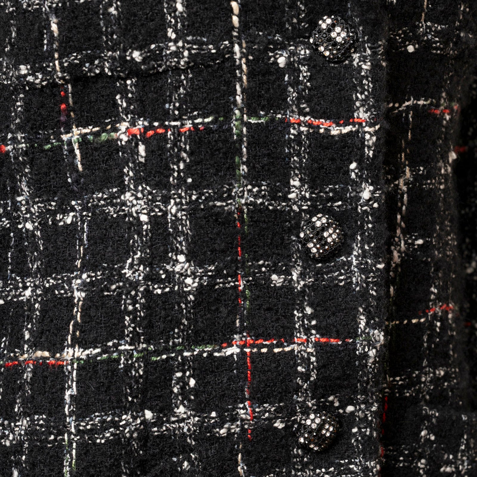 Close-up of black and white textured fabric and bejeweled buttons on Chanel Tweed Jacket 22K Black/White/Multicolor