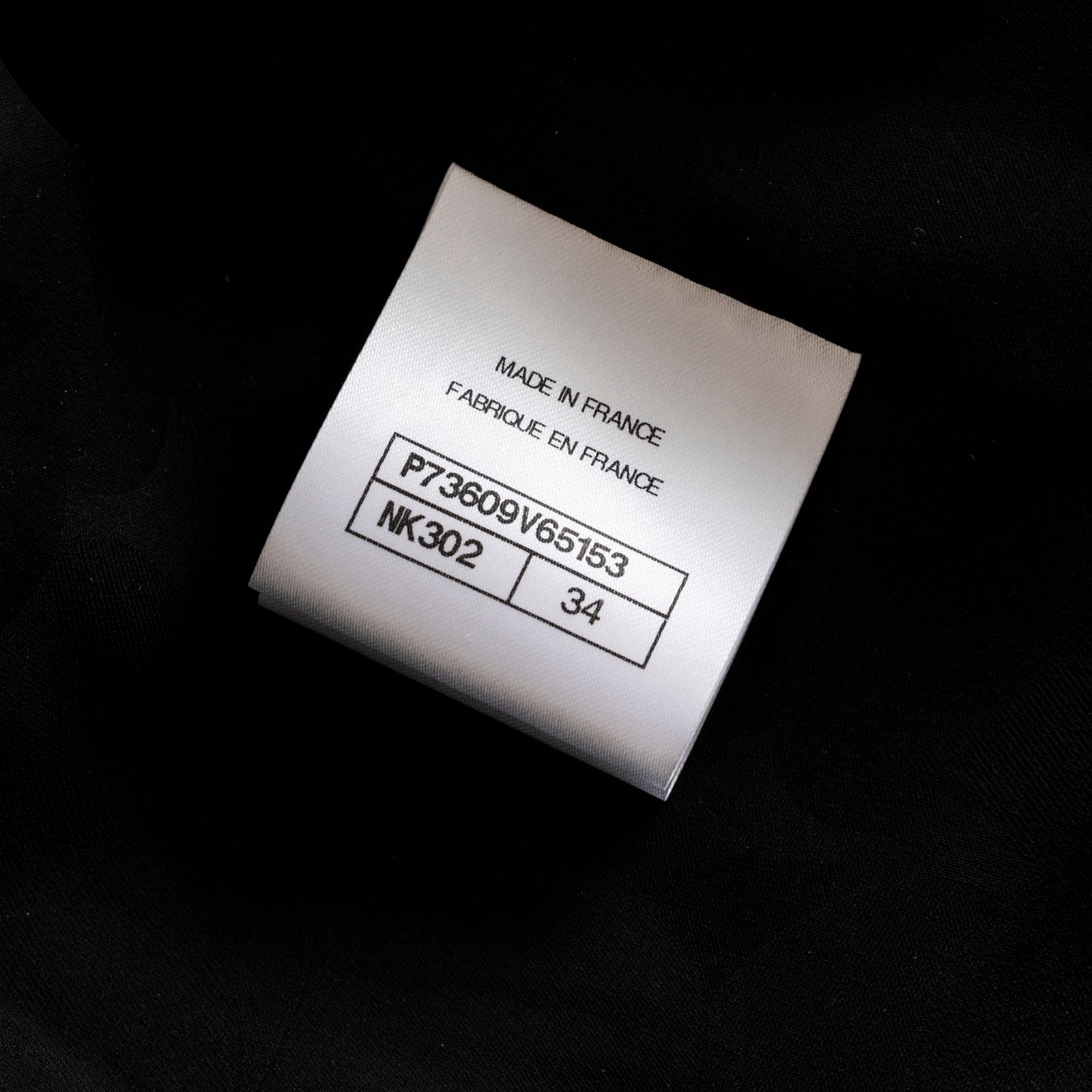 Close-up of the Chanel Tweed Jacket 22K Black/White/Multicolor label showing size 34 and Made in France tag details