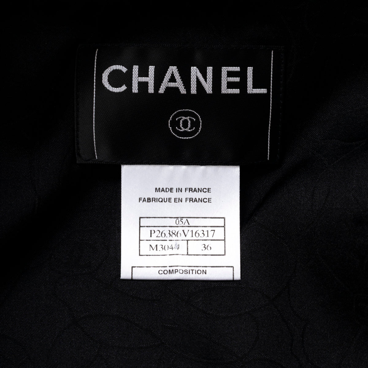 Close-up of Chanel Vintage Tweed Jacket with Butterfly Bow Tie Black & White label showing size and origin tags inside garment.