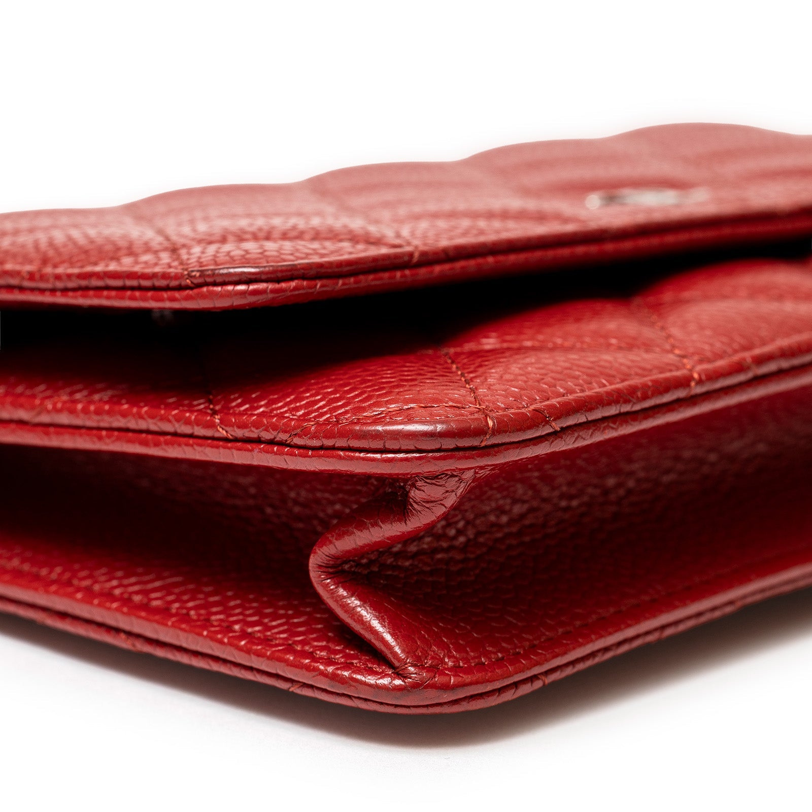 Close-up side view of Chanel Wallet On Chain Red Caviar Palladium Hardware showing textured leather and edges details
