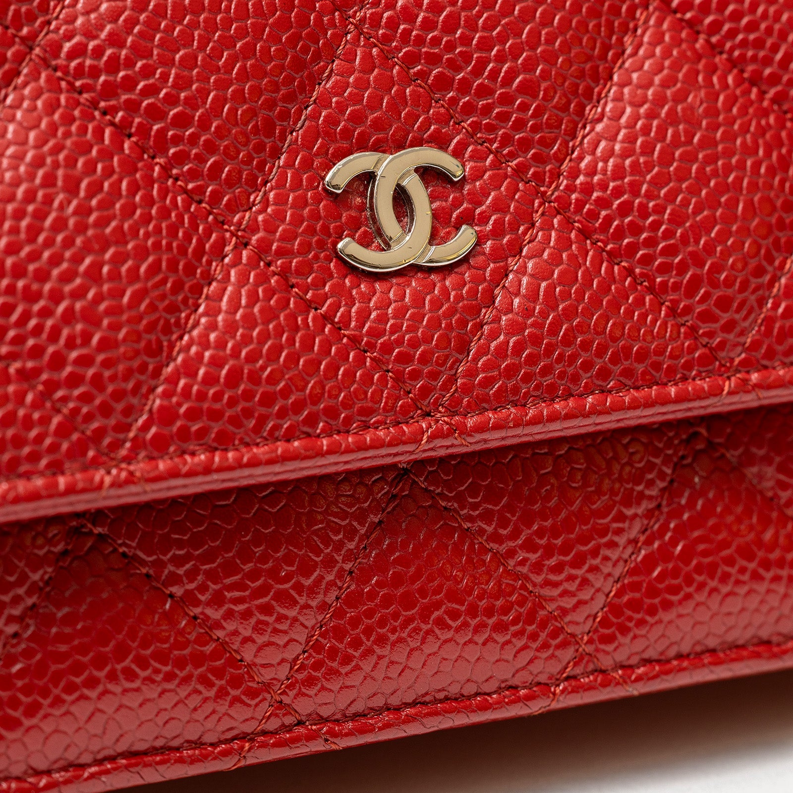 Close-up of red caviar leather and palladium hardware on Chanel Wallet On Chain Red Caviar Palladium Hardware