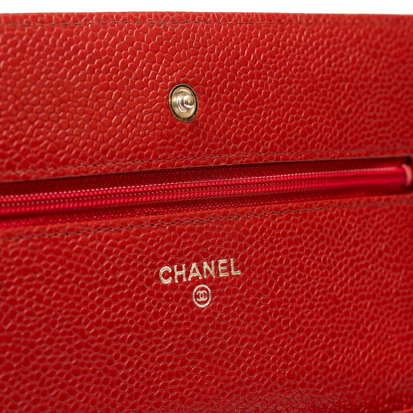 Close-up of interior zipper and gold logo detail on Chanel Wallet On Chain Red Caviar Palladium Hardware