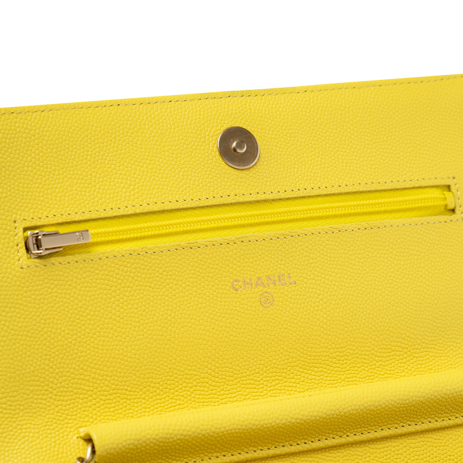 Close-up of interior zipper pocket and embossed logo on Chanel Wallet On Chain Yellow Caviar Palladium Hardware