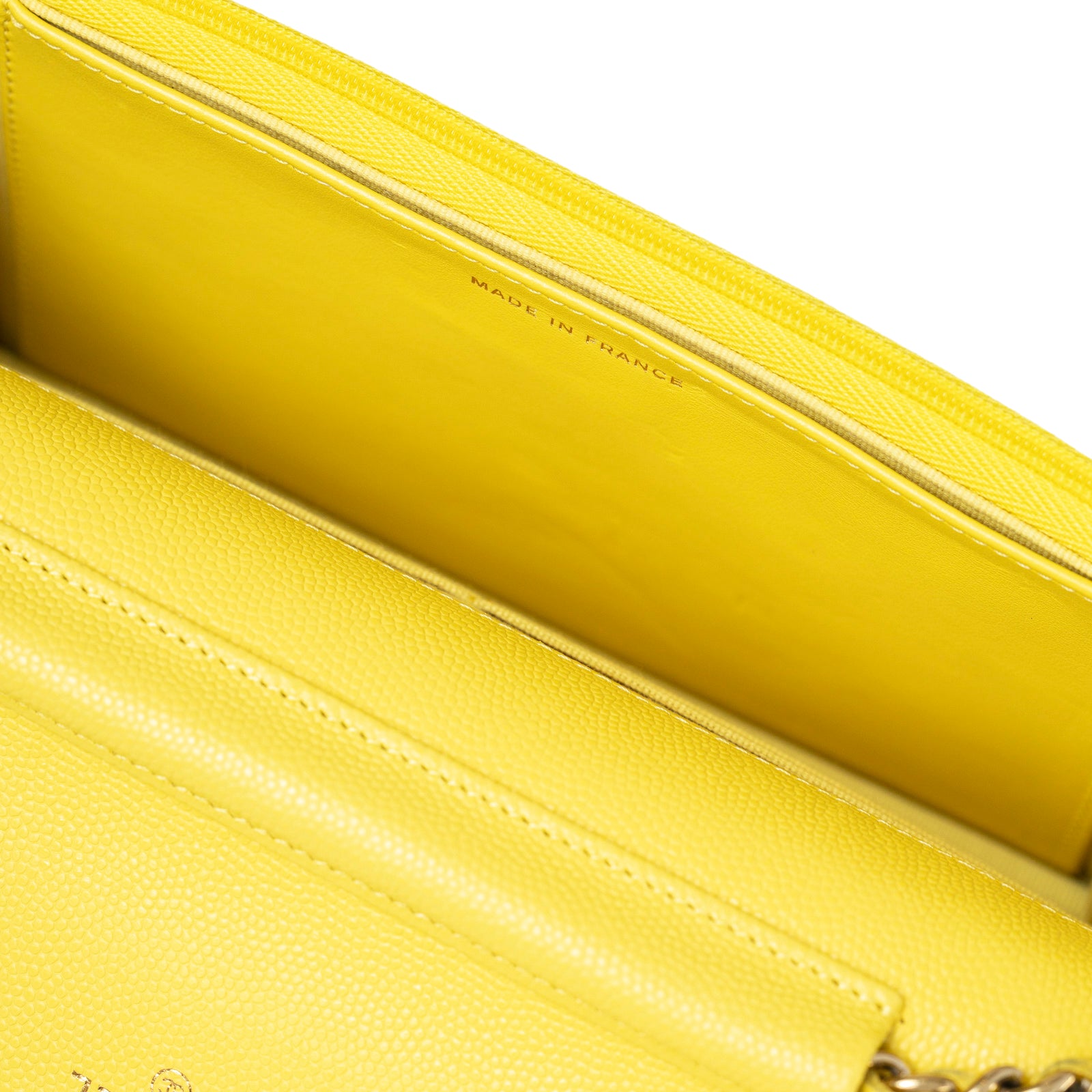Close-up interior view of Chanel Wallet On Chain Yellow Caviar Palladium Hardware showing "Made in France" stamp and textured leather