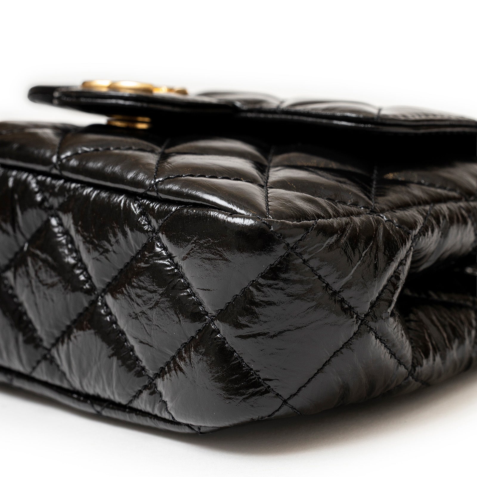 Close-up angled shot of quilted shiny calf leather on Chanel Wavy CC Hobo Small Shiny Quilted Calf Gold Hardware