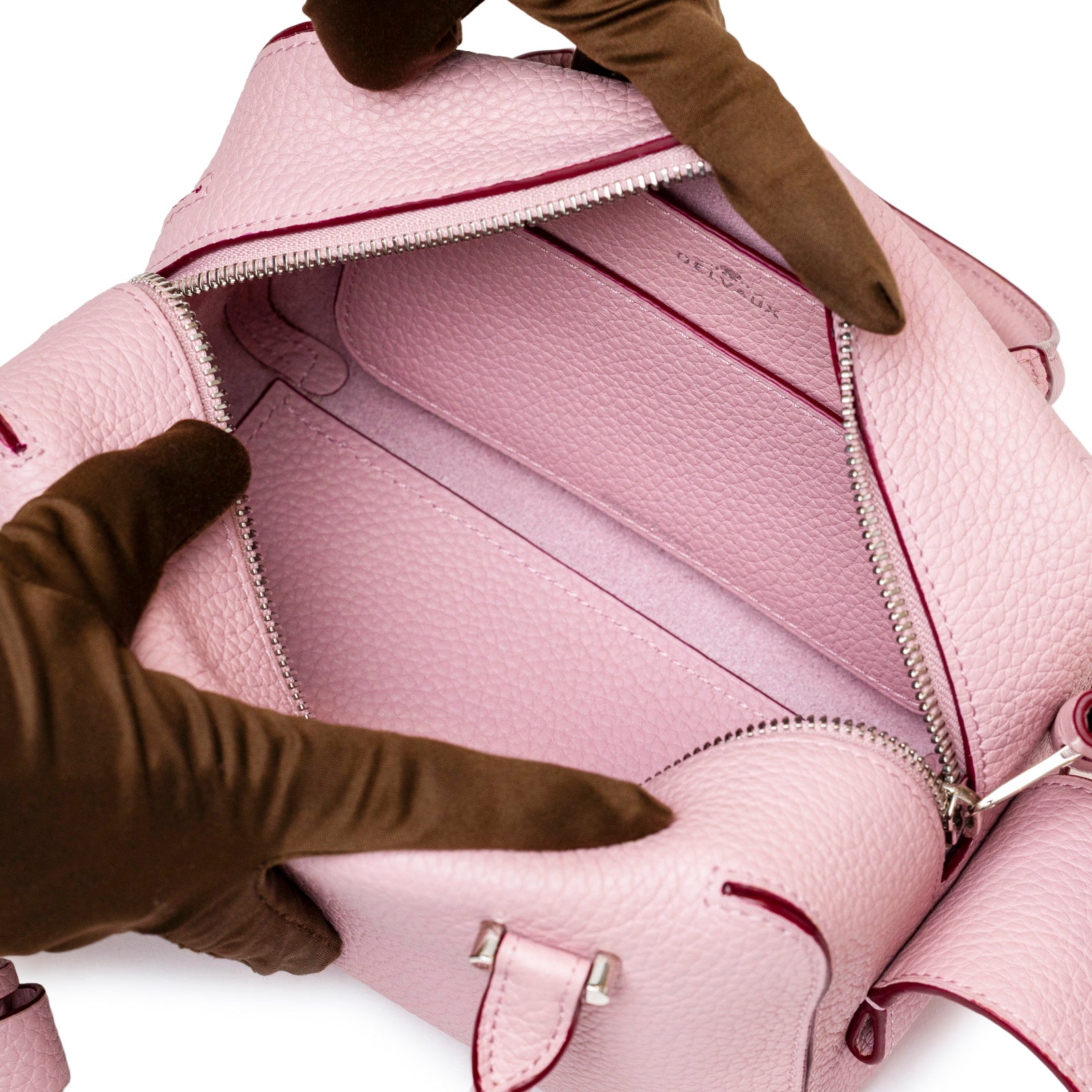 Close-up angled view of interior pocket and zipper of Delvaux Cool Box Mini Taurillon Soft Blush Palladium Hardware