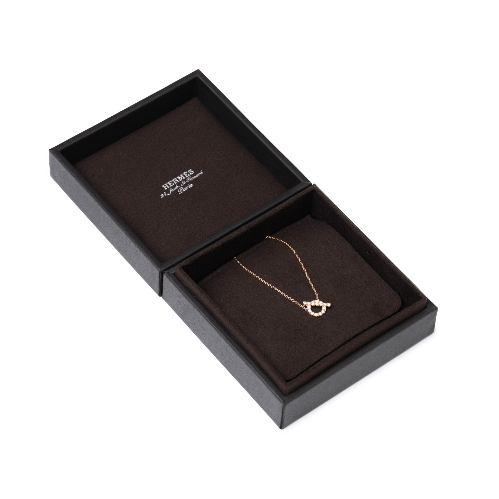 Angled view of Hermès Finesse Pendant Rose Gold Au750 displayed in signature brown presentation box with velvet cushion.