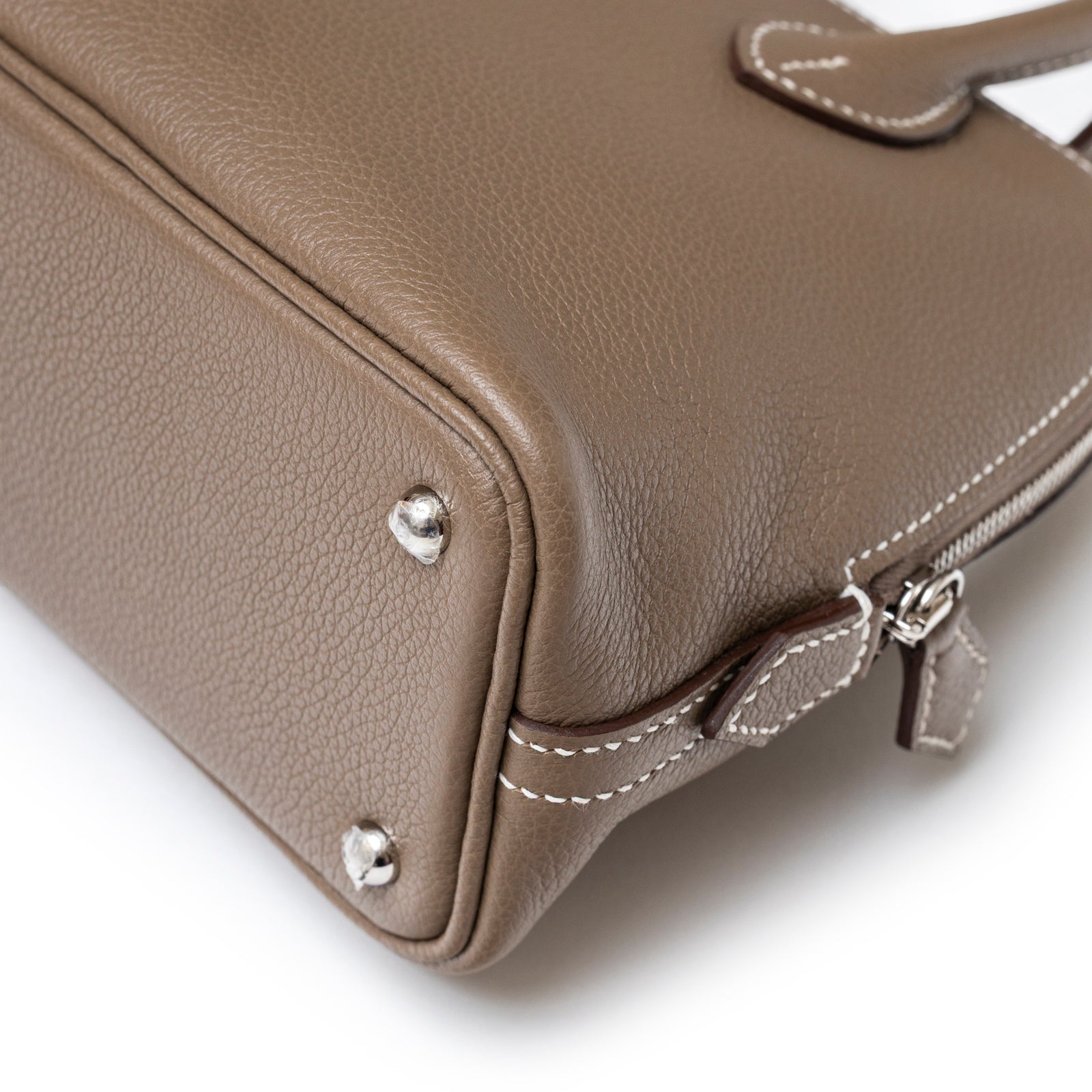 Close-up of bottom corner and hardware on Hermès 1923 Bolide Mini Etoupe Evercolor Palladium Hardware bag