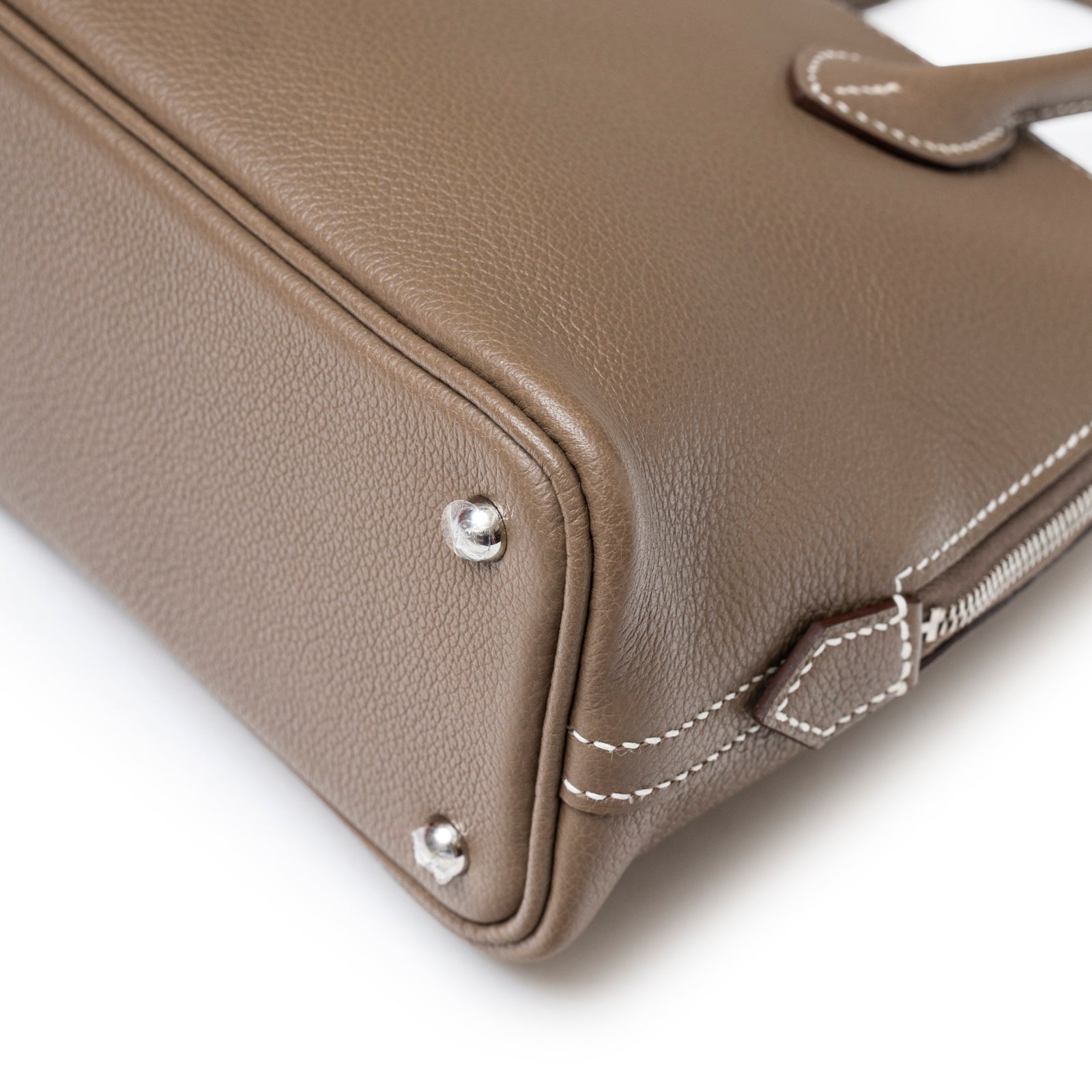 Close-up angled shot of Hermès 1923 Bolide Mini Etoupe Evercolor Palladium Hardware corner with stitching detail