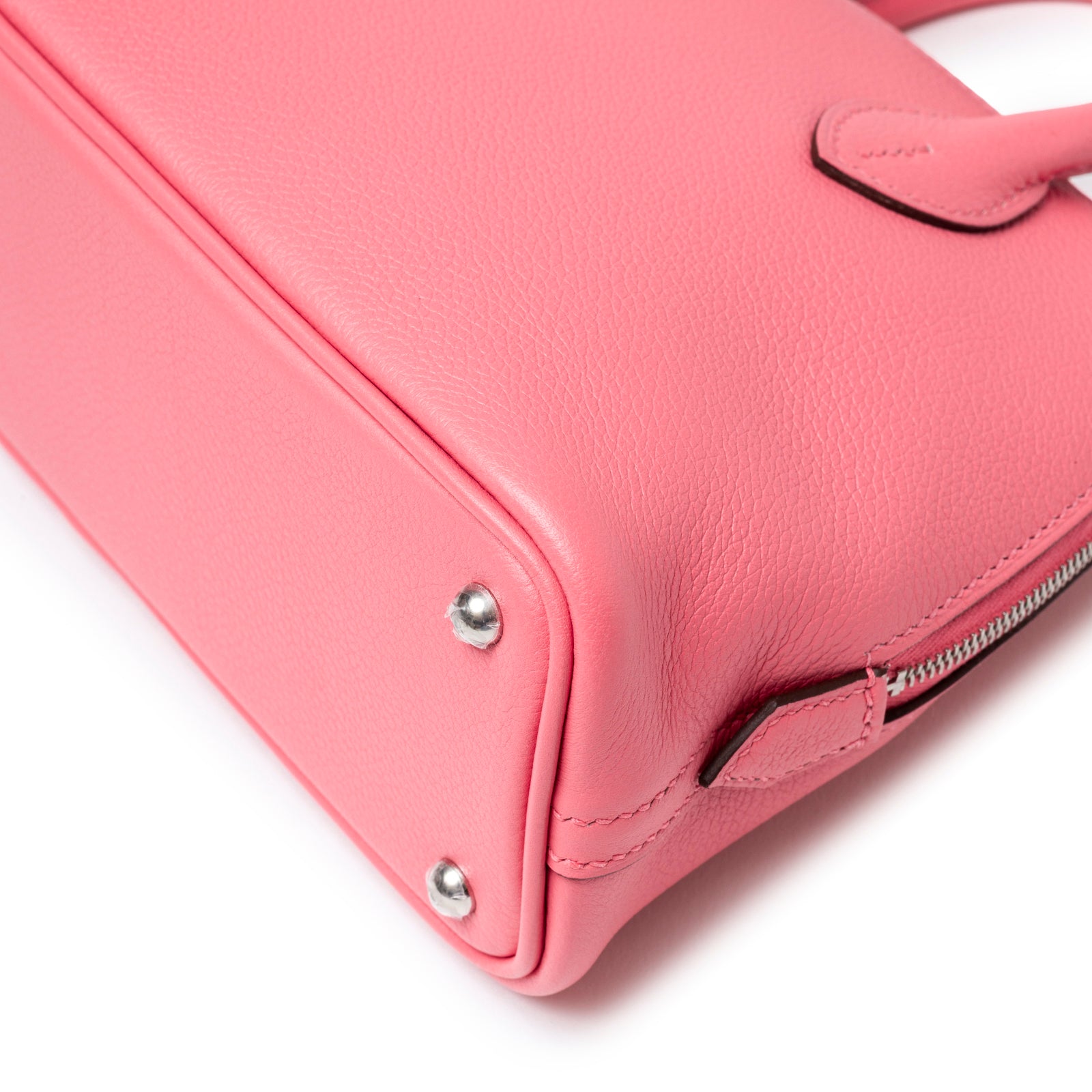 Close-up of base corner showing smooth pink leather and palladium studs on Hermès 1923 Bolide Mini Rose Azalee Swift Palladium Hardware