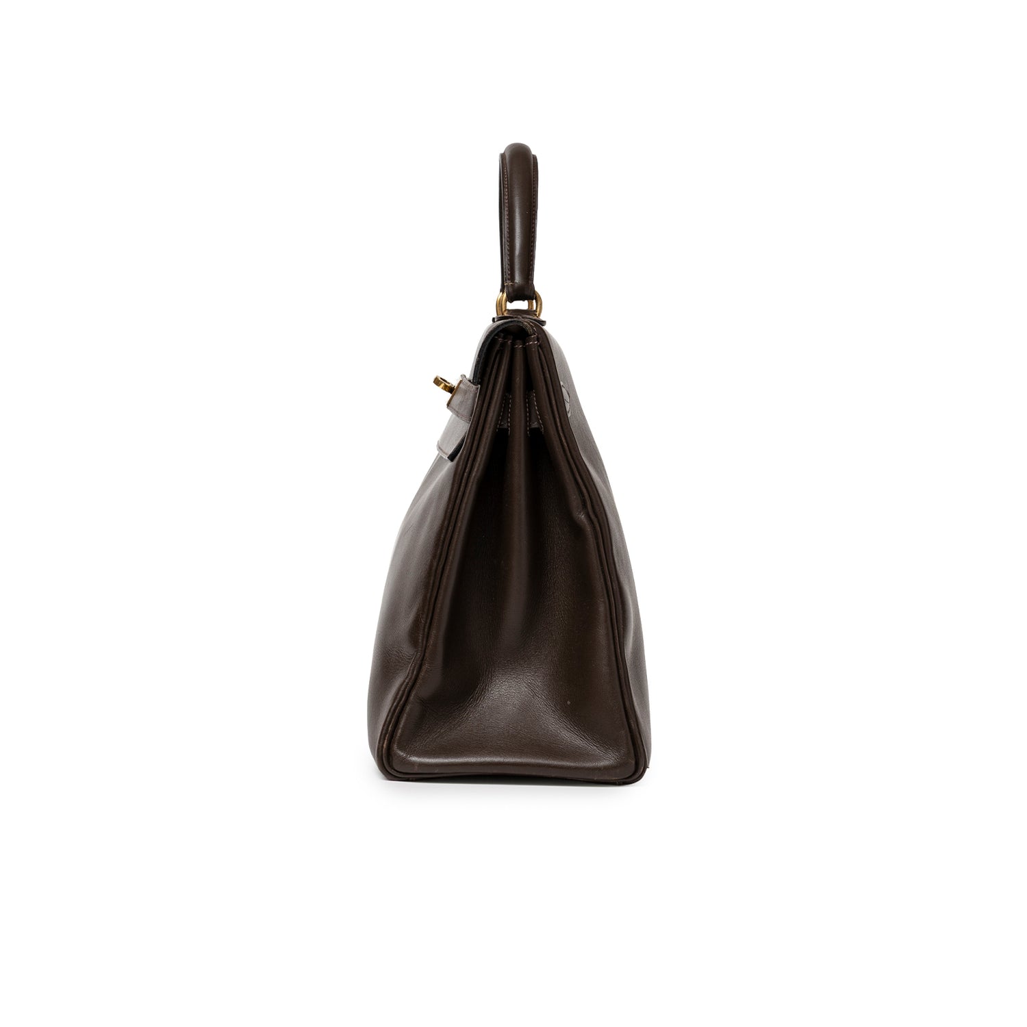 Side profile of Hermès 1974 Vintage Kelly 32 Marron Foncé Box Gold Hardware showing smooth leather and handle details