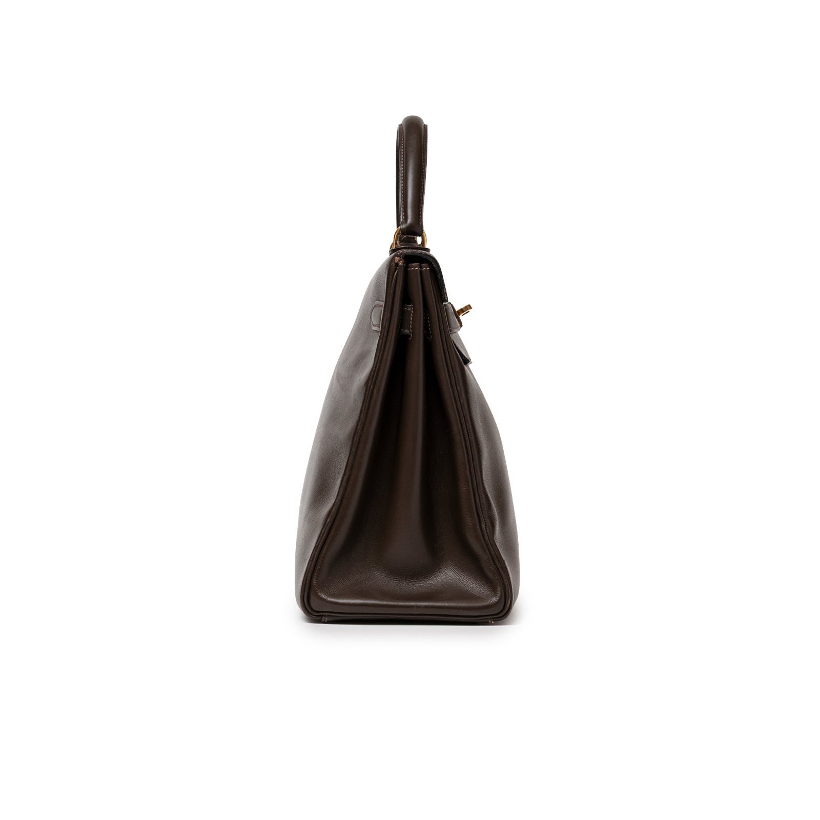 Side profile of Hermès 1974 Vintage Kelly 32 Marron Foncé Box Gold Hardware showing smooth leather and handle detail