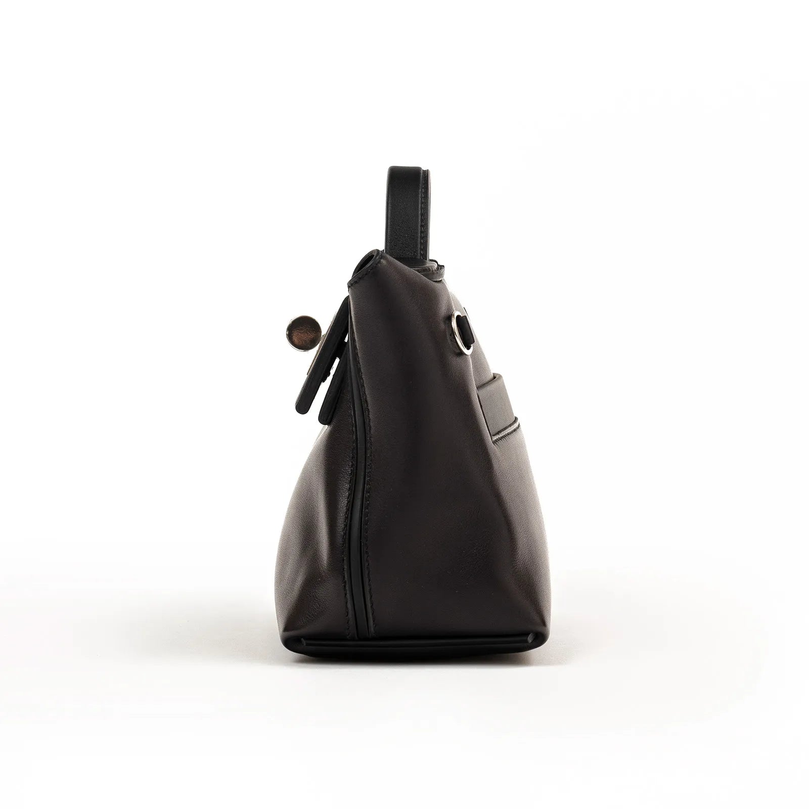Side view of black leather Hermès 24/24 21 with smooth silhouette and palladium hardware details