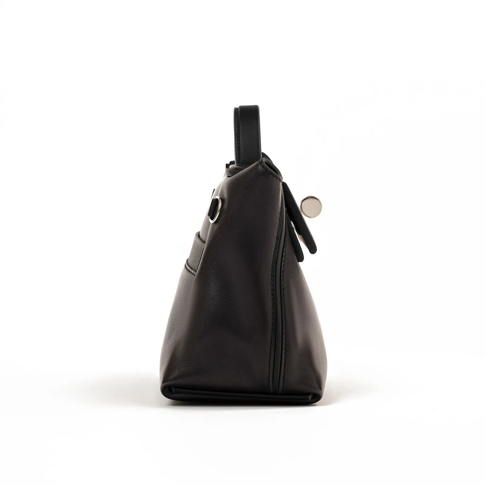 Side profile view of Hermès 24/24 21 in black Volupto leather with palladium hardware detailing