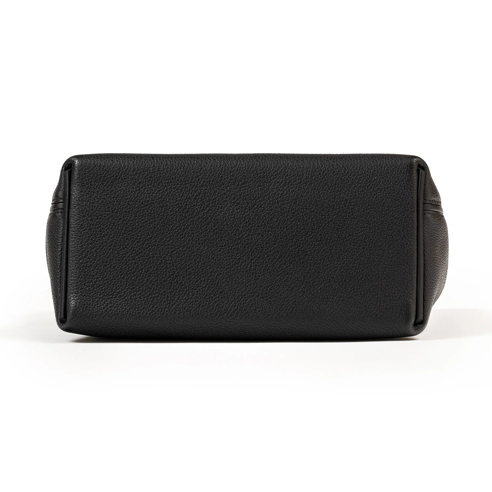Bottom view of black Taurillon leather Hermès 24/24 29 Sac bag showcasing smooth grain texture