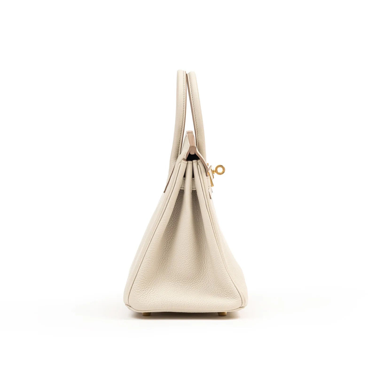 Side profile of Hermès Birkin 25 in Beton togo leather with gold hardware showing structured silhouette and handle detail