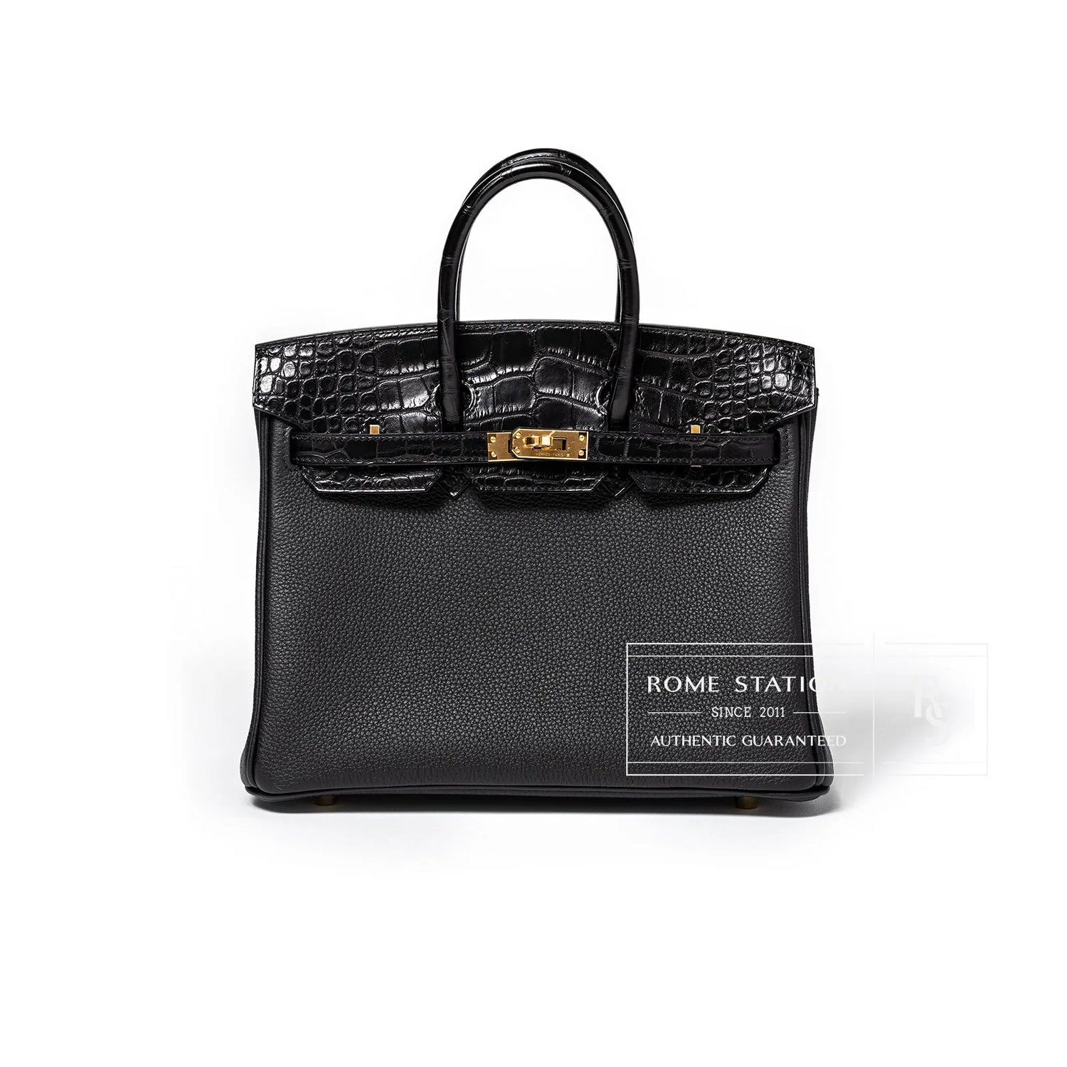 Front view of black Birkin 25 featuring textured togo body and matte alligator flap with gold hardware clasp detail