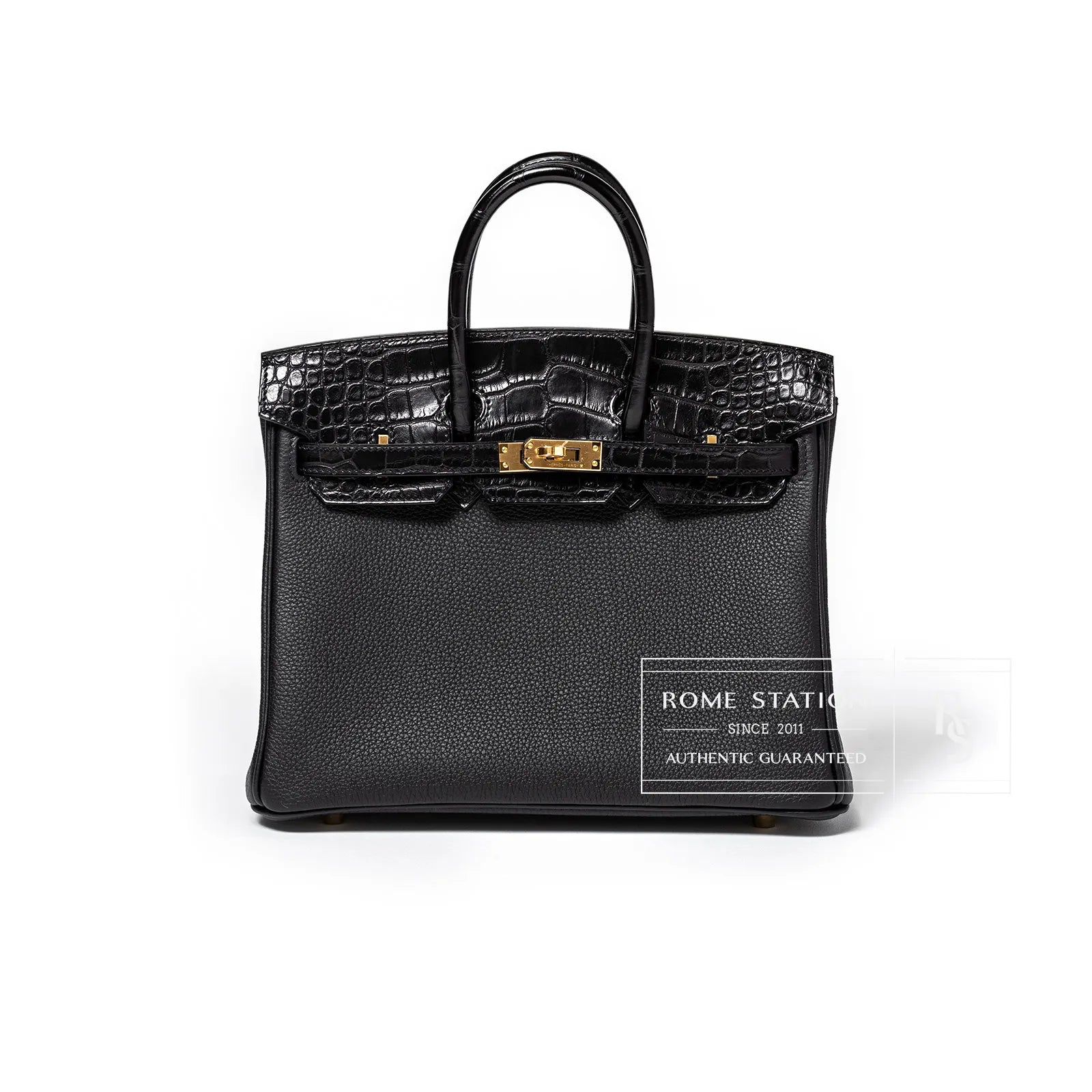 Front view of black Birkin 25 featuring textured togo body and matte alligator flap with gold hardware clasp detail