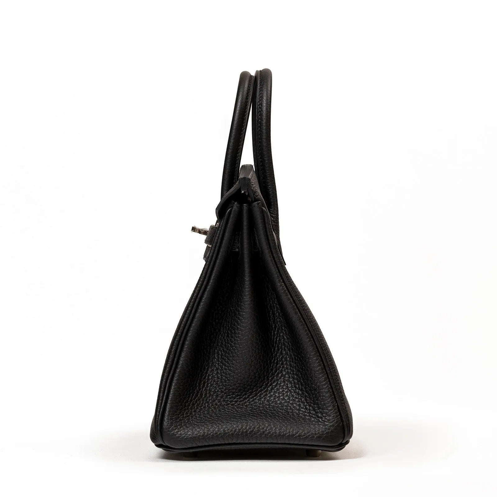 Side angle of Hermès Birkin 25 in black togo leather showing the bag’s structured silhouette and handle detail