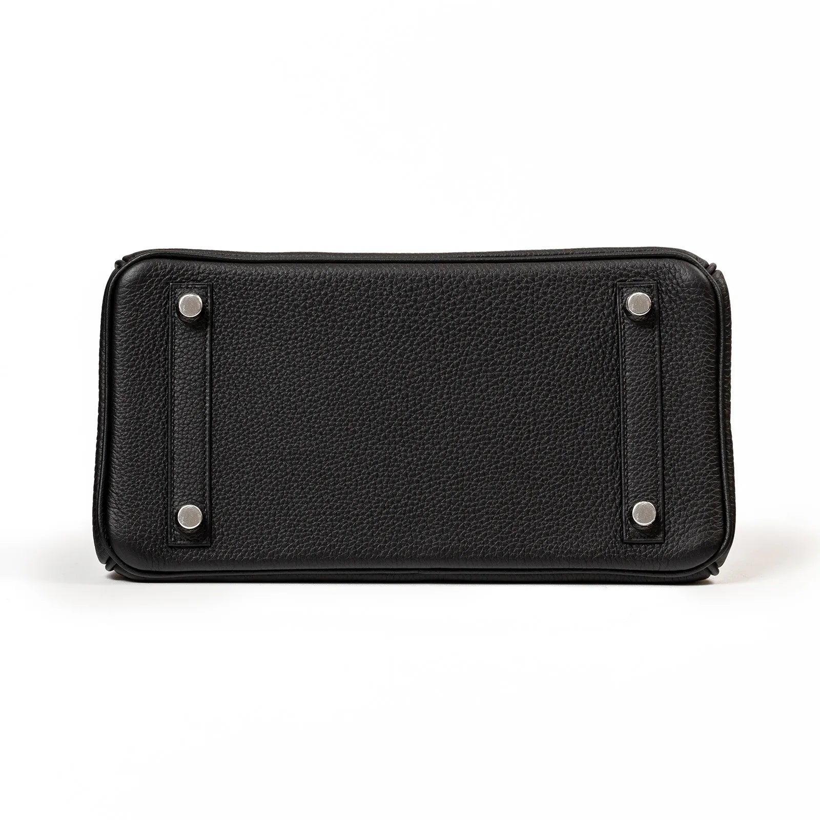 Bottom view of Hermès Birkin 25 handbag in black Togo leather showing protective palladium hardware feet and texture details