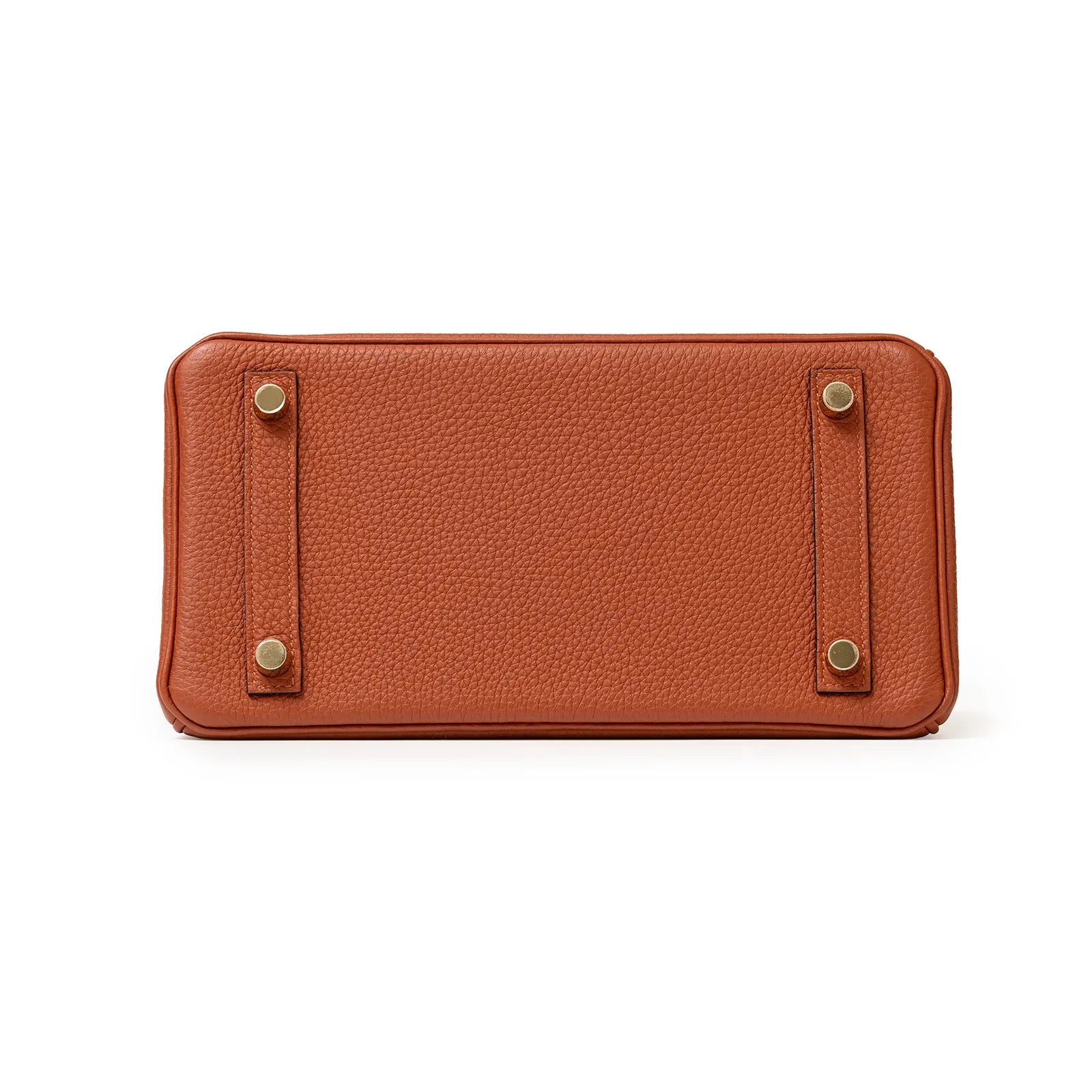 Bottom view of Birkin 25 bag in rich cuivre togo leather showing gold hardware studs and textured base