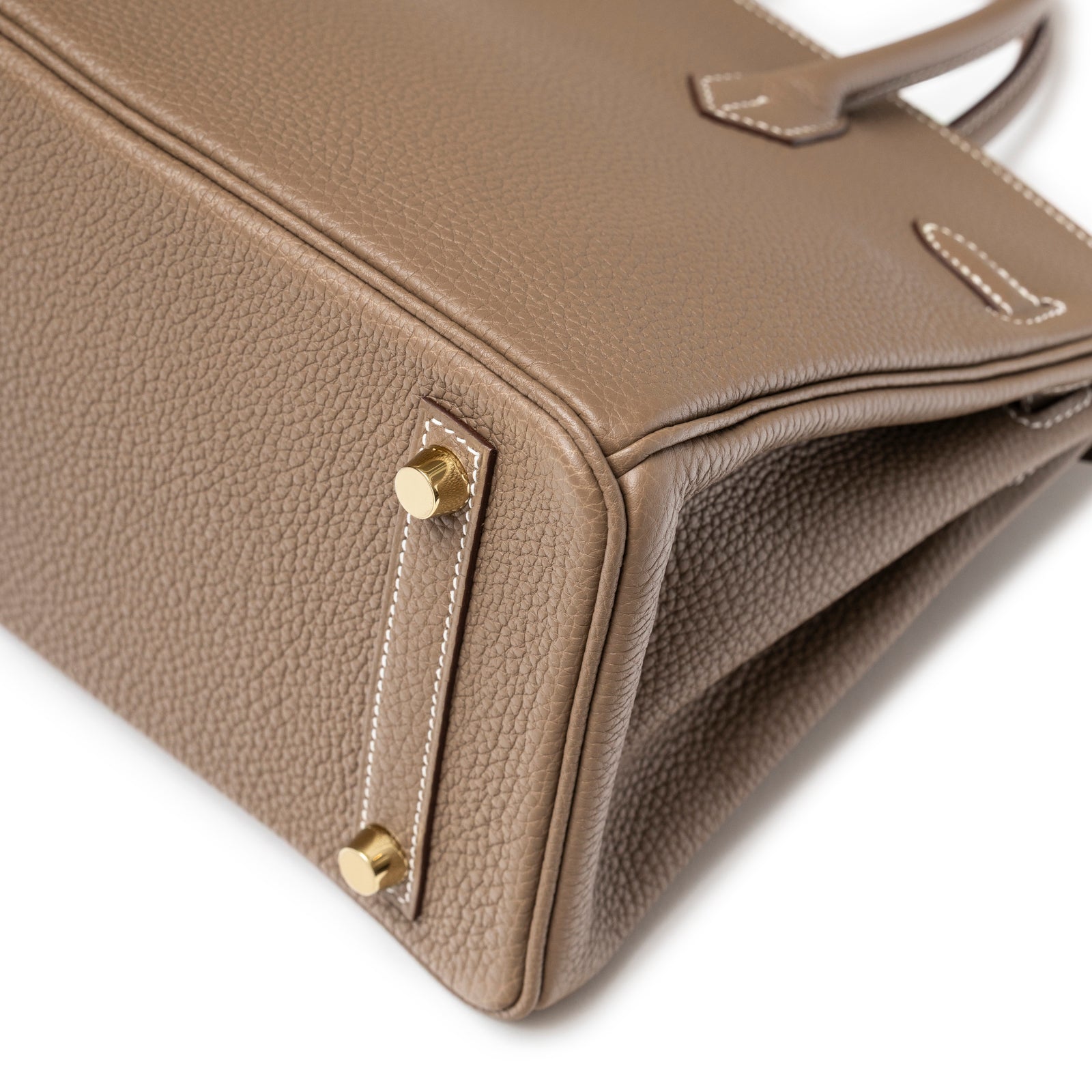 Close-up of bottom corner showing taupe textured leather and gold feet on Hermès Birkin 25 Etoupe Togo Gold Hardware