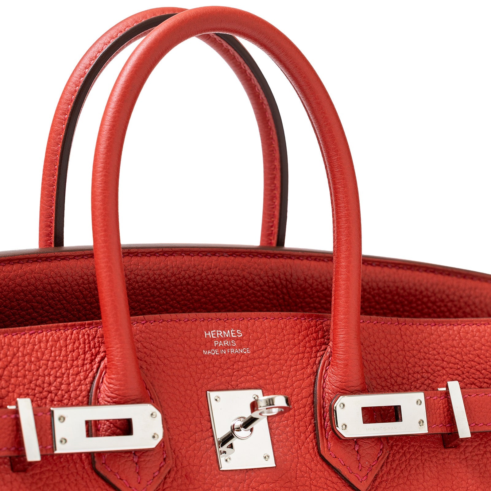 Close-up of front view Hermès Birkin 25 Geranium Togo leather with palladium hardware and embossed logo.