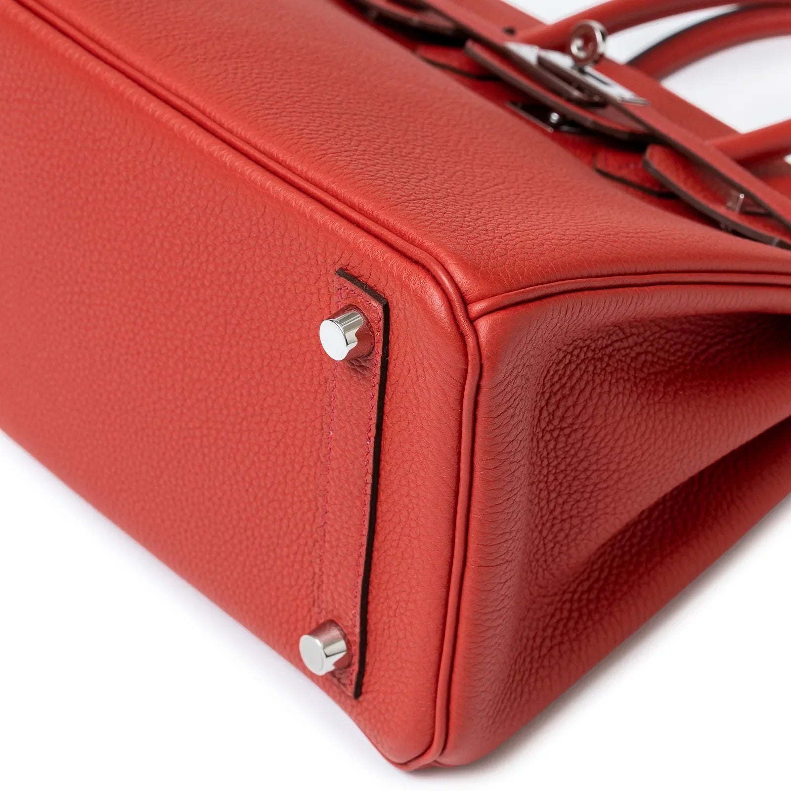 Close-up of base and palladium hardware on Hermès Birkin 25 Geranium Togo leather handbag