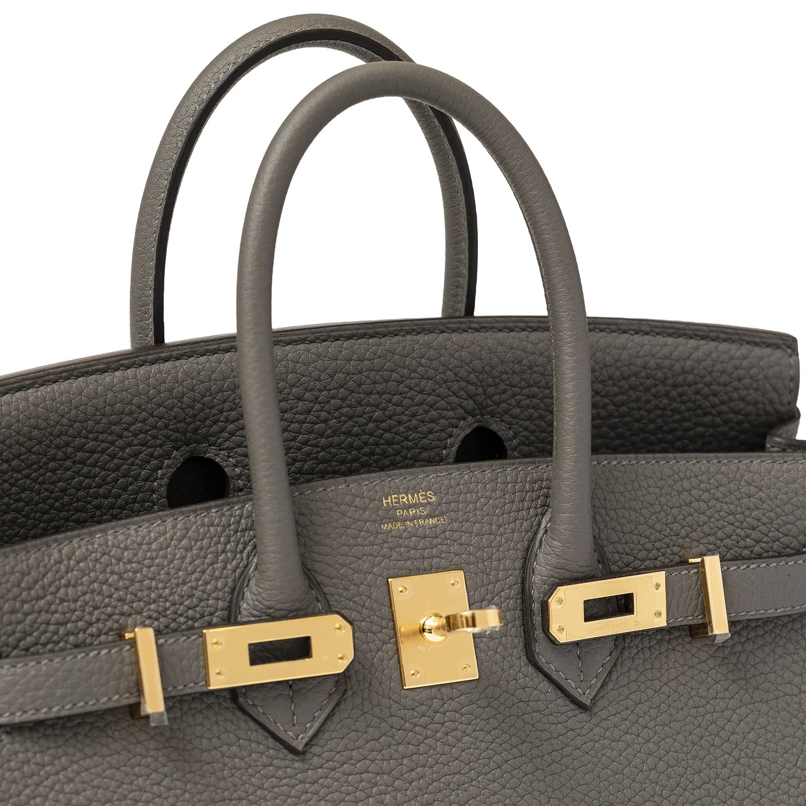 Close-up angled shot of Hermès Birkin 25 in Gris Meyer togo leather with gold hardware and visible logo stamp
