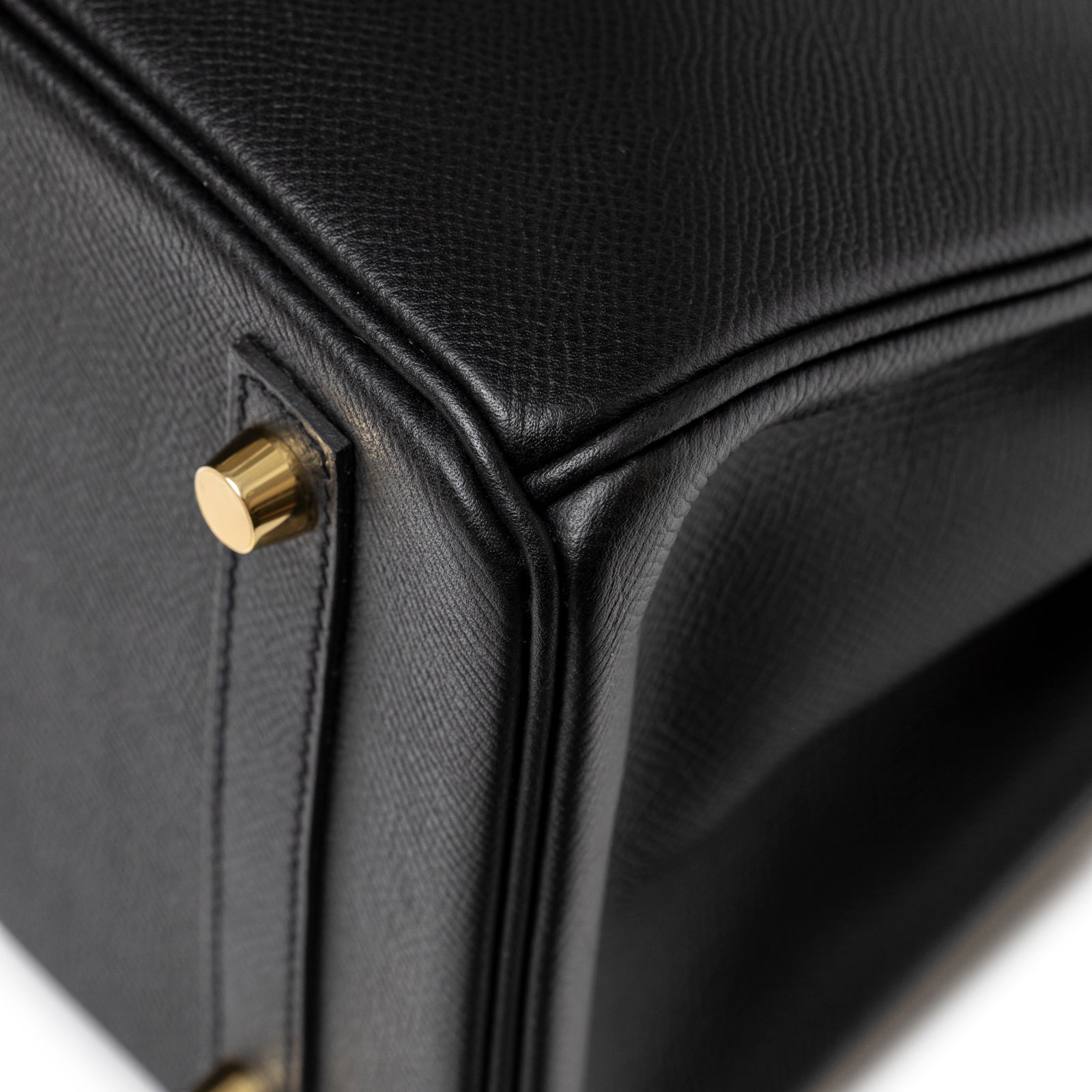 Close-up of Hermès Birkin 30 Black Epsom Gold Hardware bottom corner showing textured leather and gold stud detail
