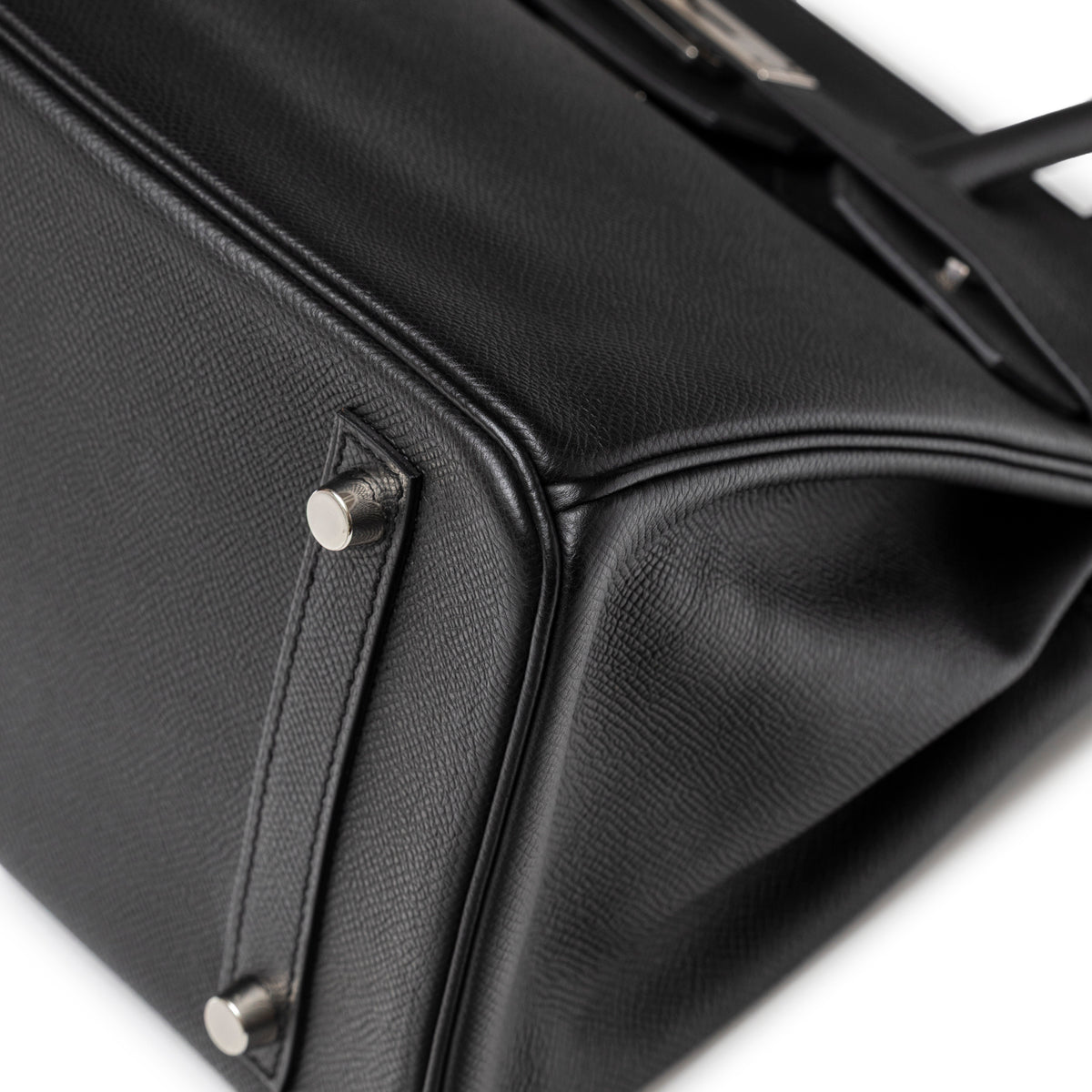 Close-up of Hermès Birkin 30 Black Epsom Palladium Hardware showing leather texture and protective metal feet detail