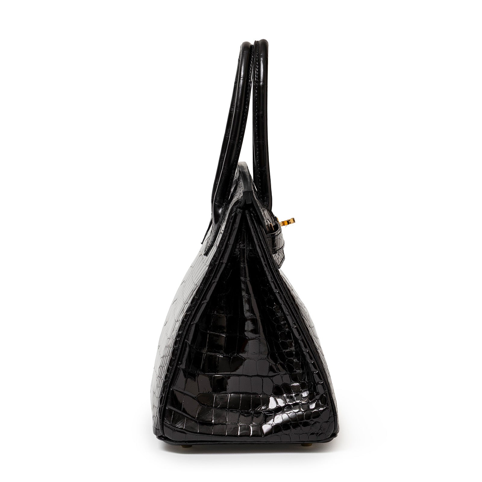 Side view of Hermès Birkin 30 Black Shiny Porosus Crocodile handbag with gold hardware and double handles.