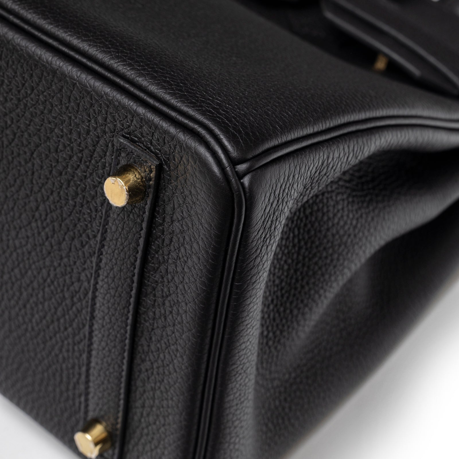 Close-up of the base corner and gold hardware feet on Hermès Birkin 30 Black Togo Gold Hardware handbag