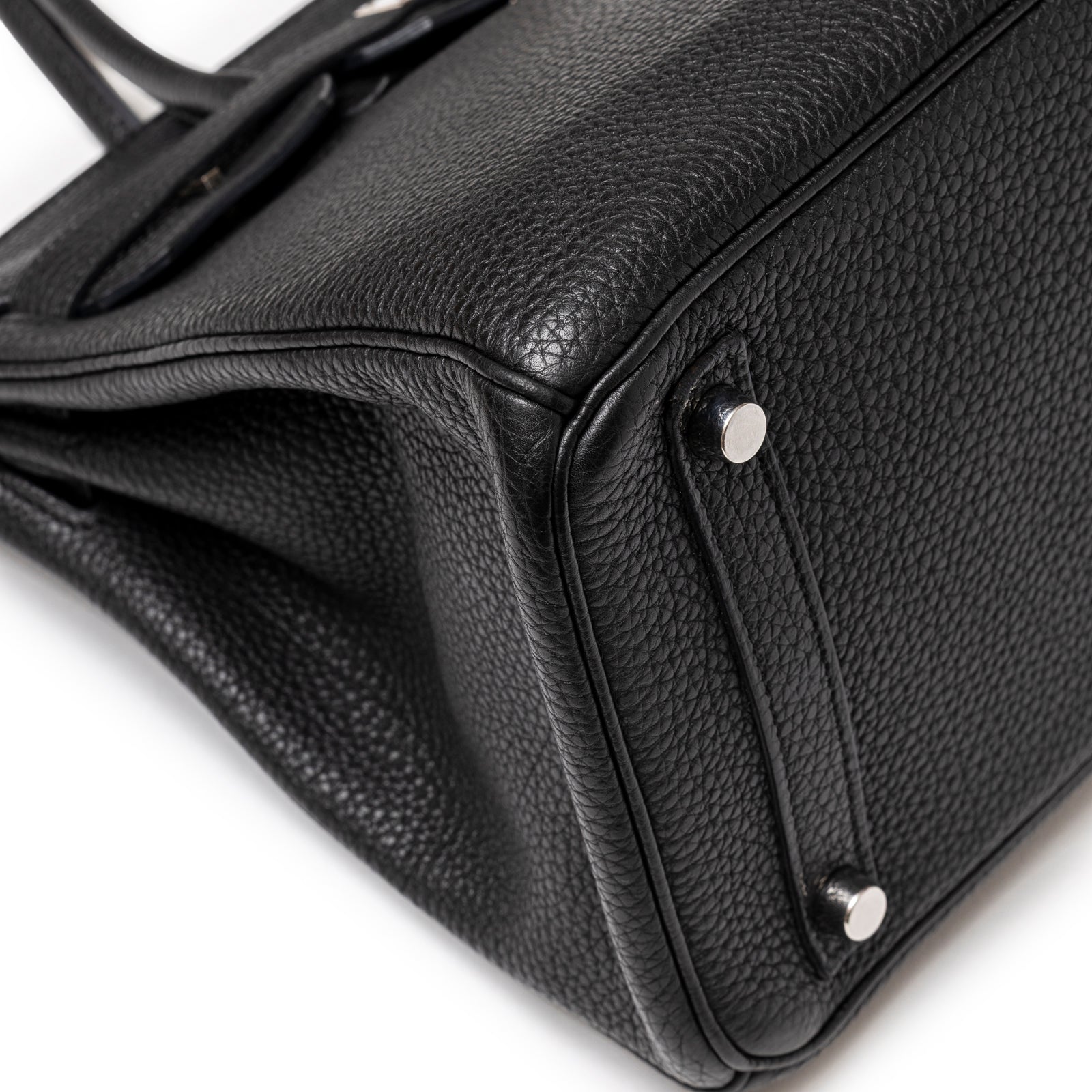 Close-up of bottom corner and feet on Hermès Birkin 30 Black Togo Palladium Hardware showing textured leather detail