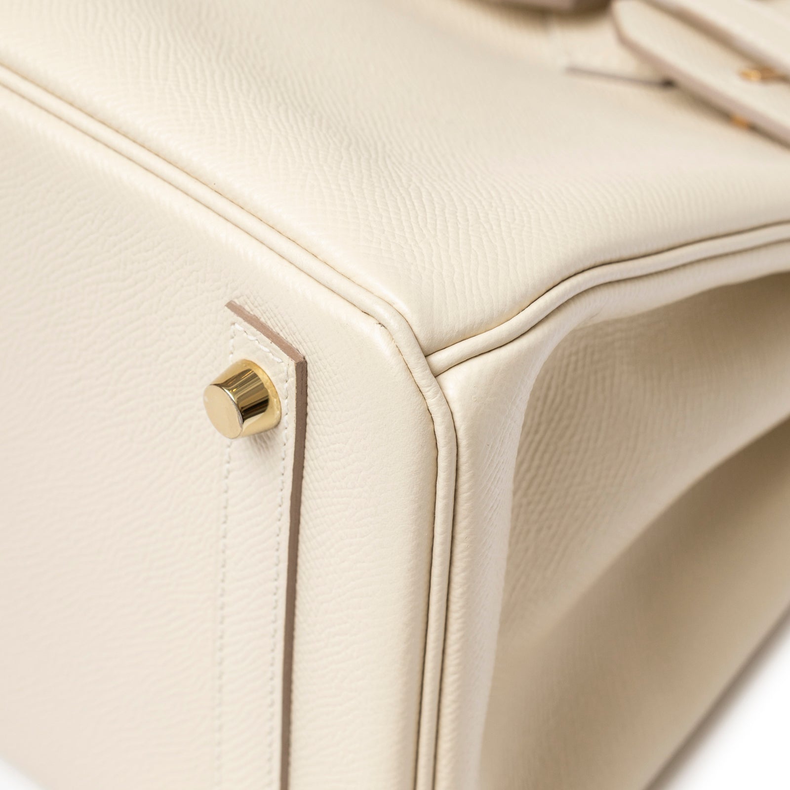 Close-up of Hermès Birkin 30 Craie Epsom Gold Hardware corner showing cream leather texture and gold feet detail