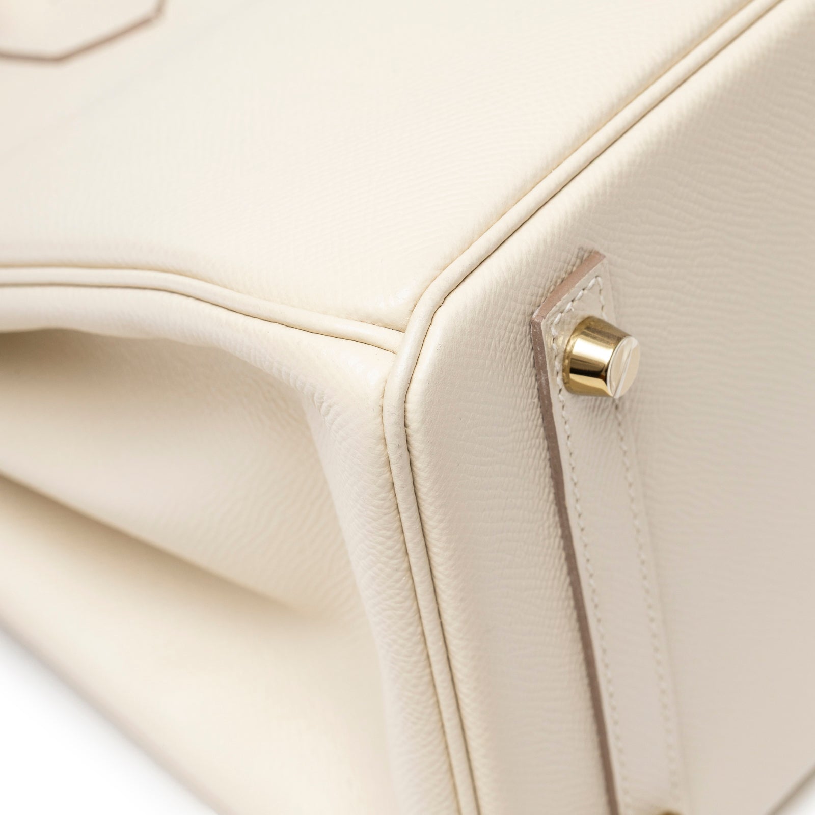 Detailed close-up of Hermès Birkin 30 Craie Epsom Gold Hardware base corner showing cream leather texture and gold stud detail
